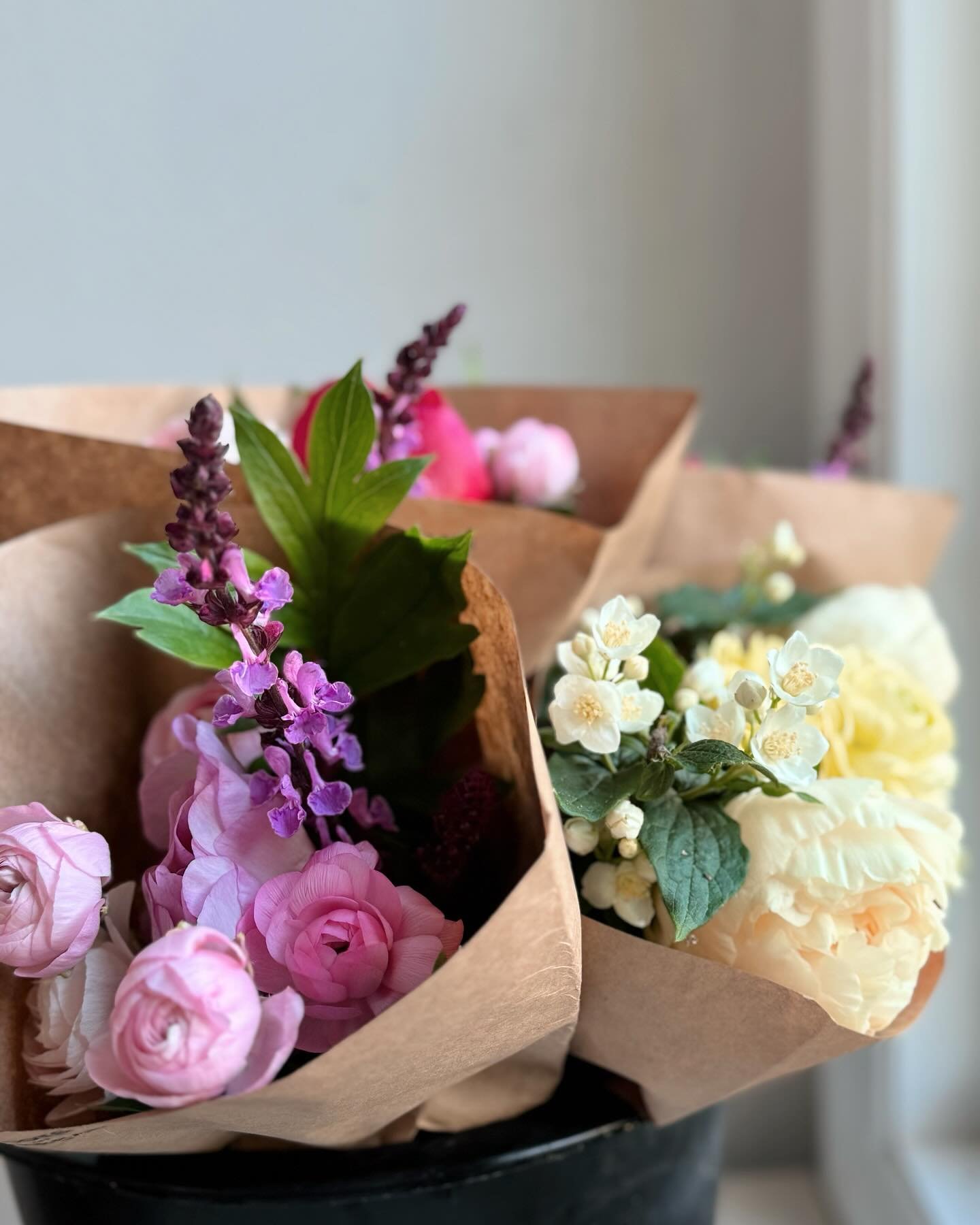 Refreshed bouquets @greisers - Wrapped in kraft paper, rooted in love&hellip; lush peonies, ruffled ranunculus, salvia singing in purple notes, and mock orange carrying the scent of early summer.