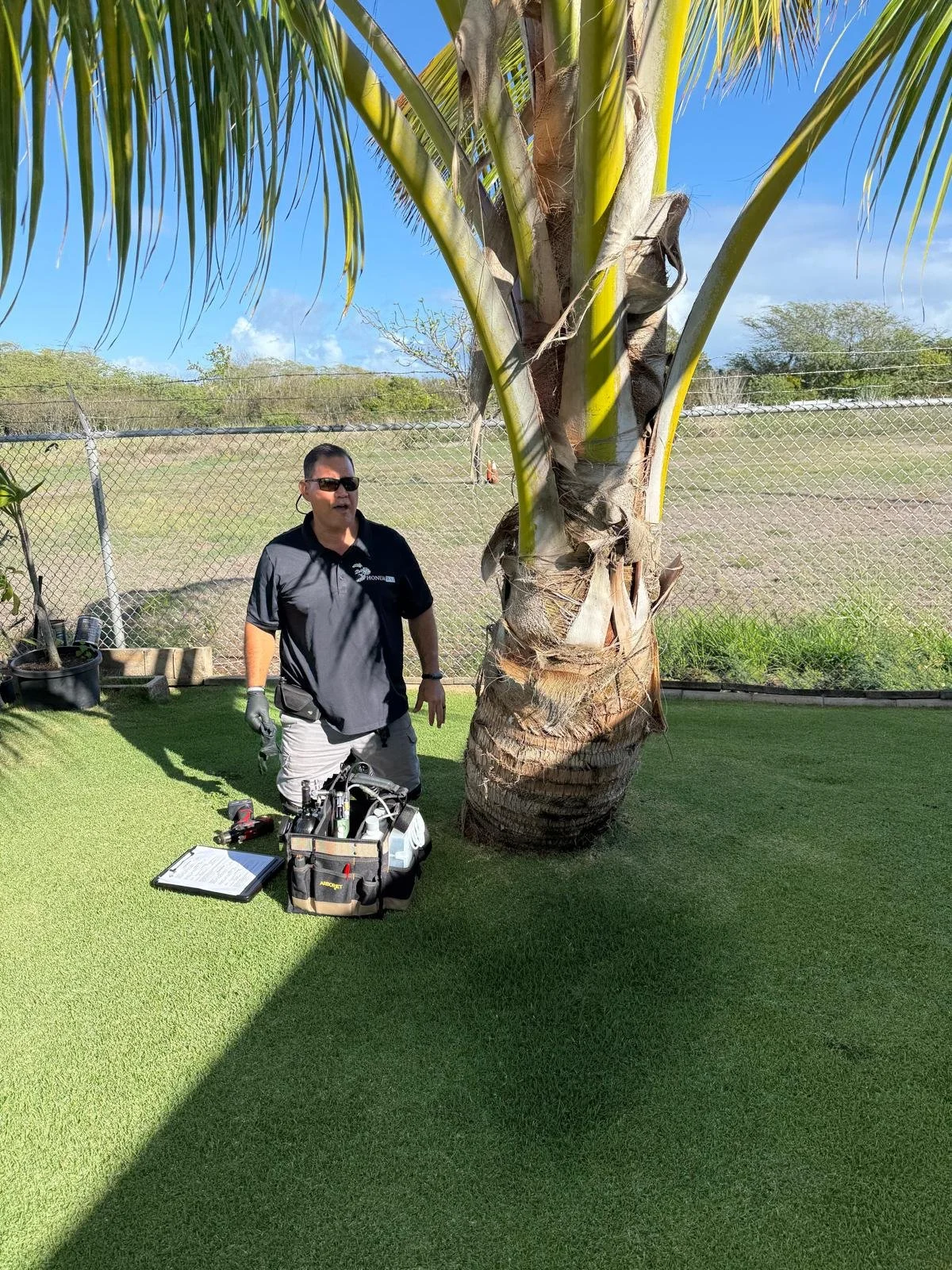 Joshua Pokipala of HonuaWai performing CRB tree injections with the ArborJet system for optimal efficiency.