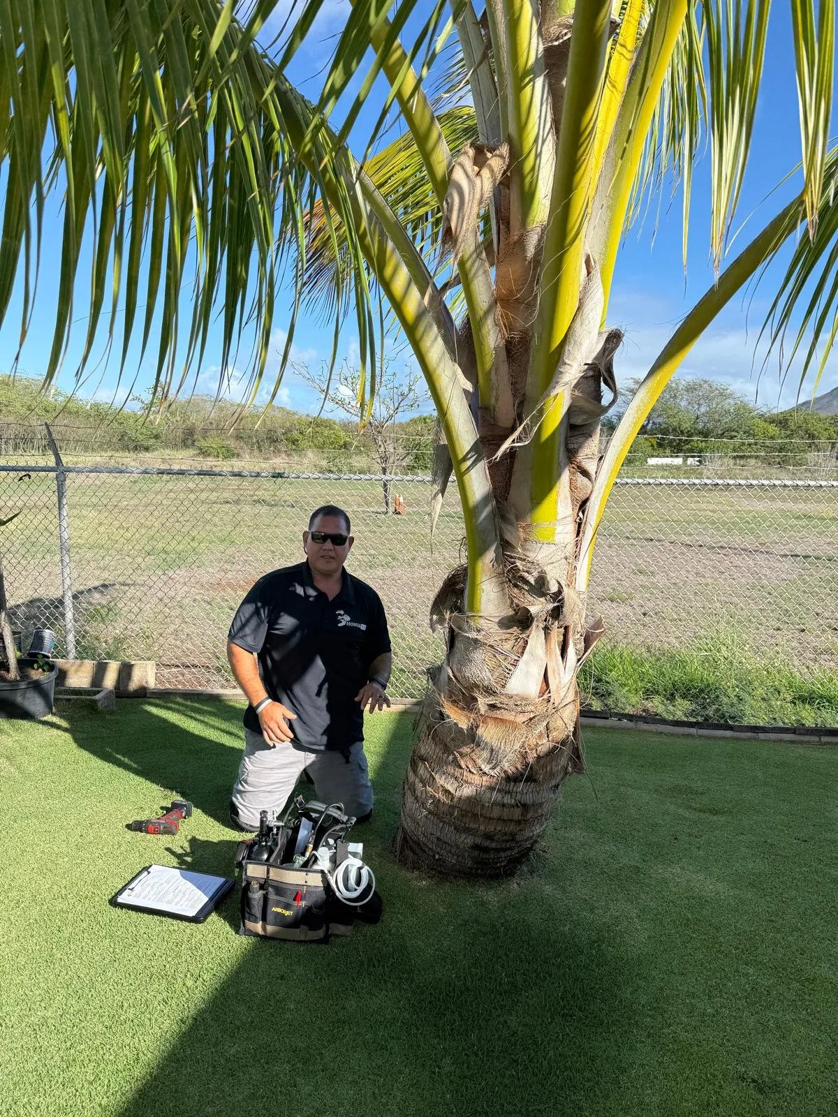 Joshua Pokipala of HonuaWai performing CRB tree injections with the ArborJet system for optimal efficiency.