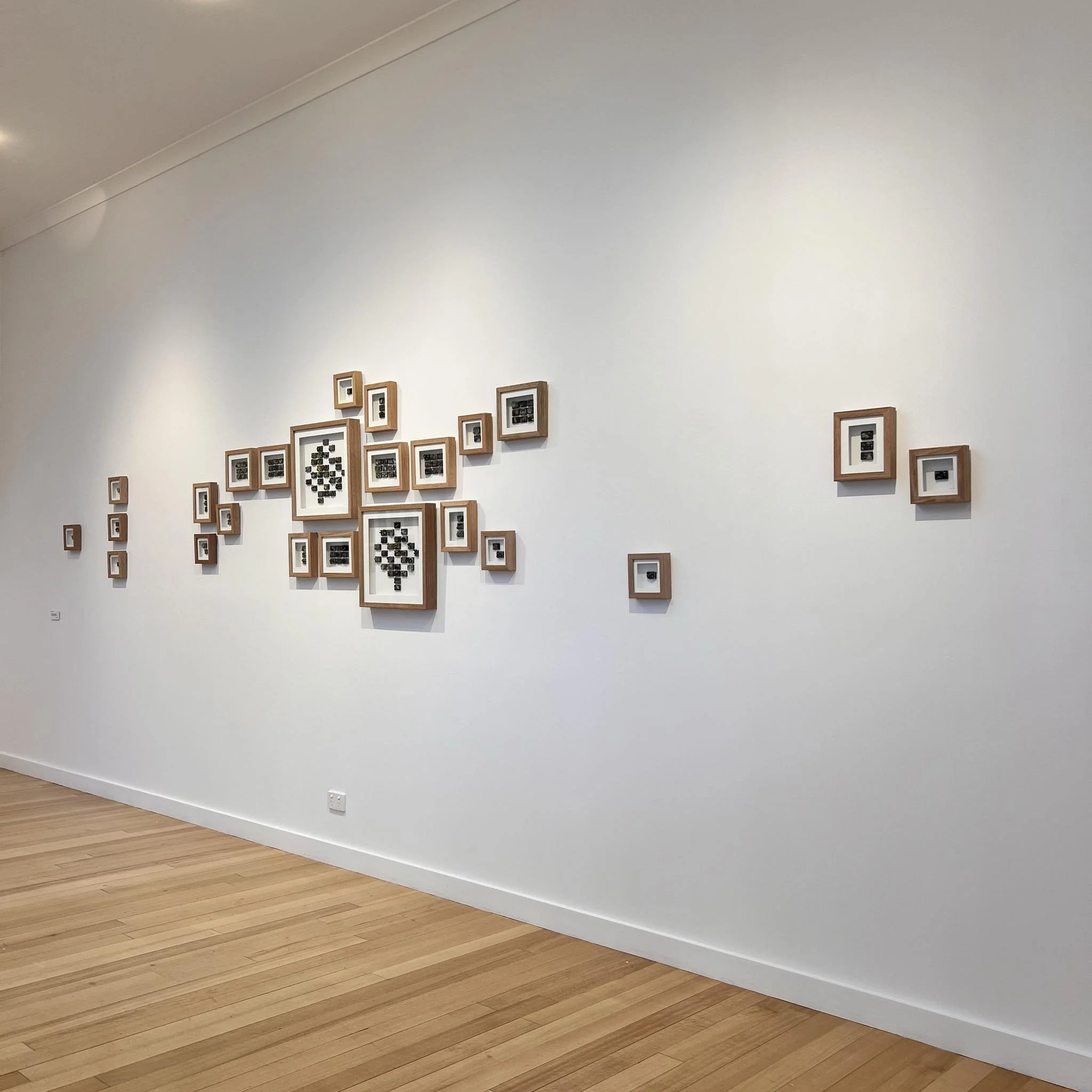 Forest Fragments Miniatures (2024), in-situ at Cradle Mountain WIlderness Gallery, Tasmania small-scale ceramic tiles inspired by lichens, fungi, and moss from Tasmania’s forest ecosystems.