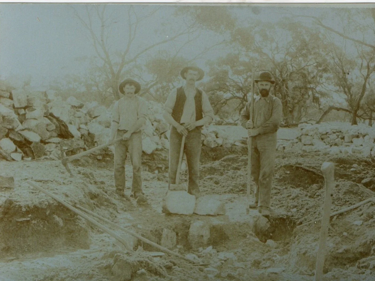 Men working in a limestone quarry cutting stone by hand