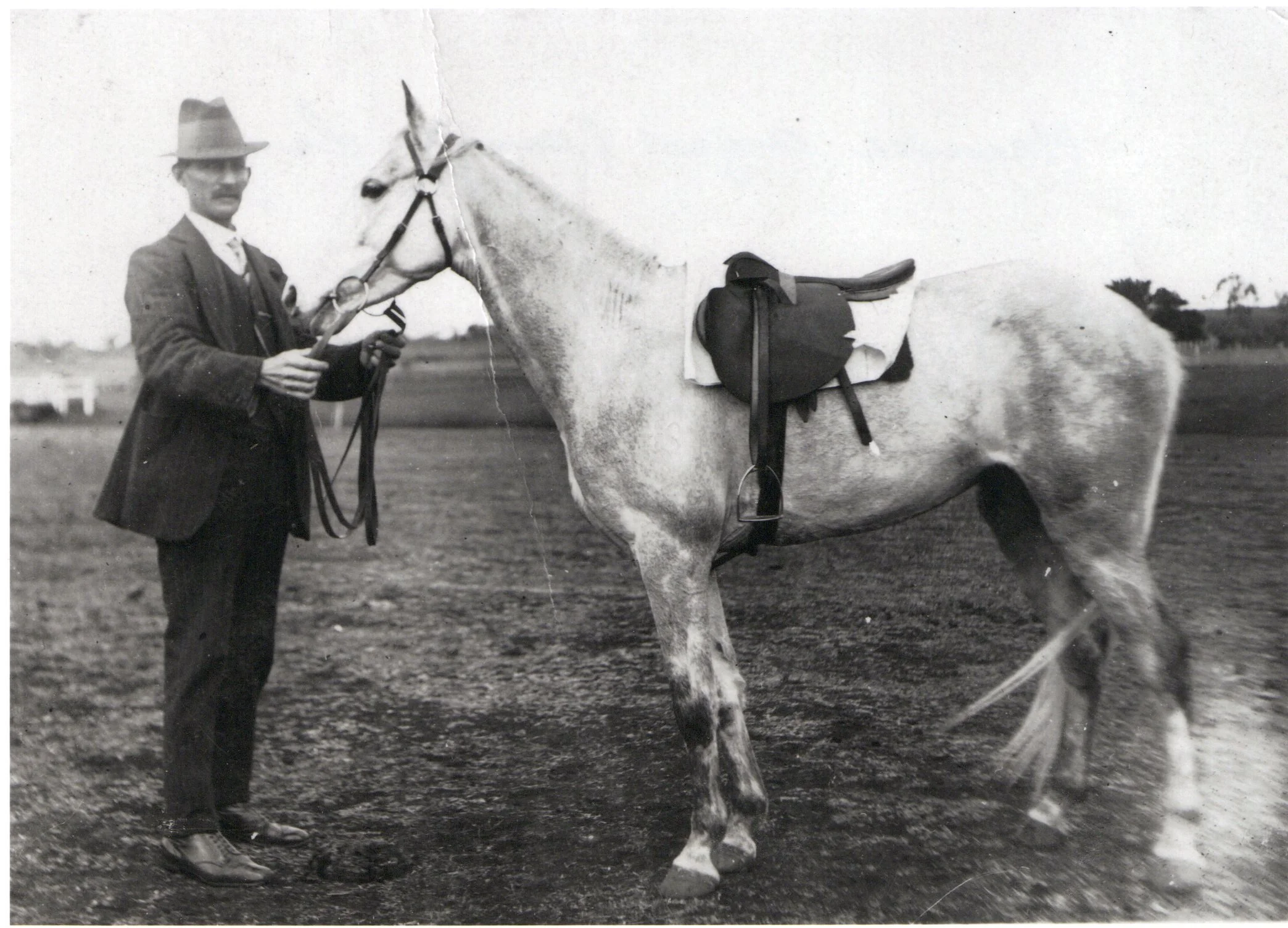 Harry Lange standing with his horse in rural Victoria