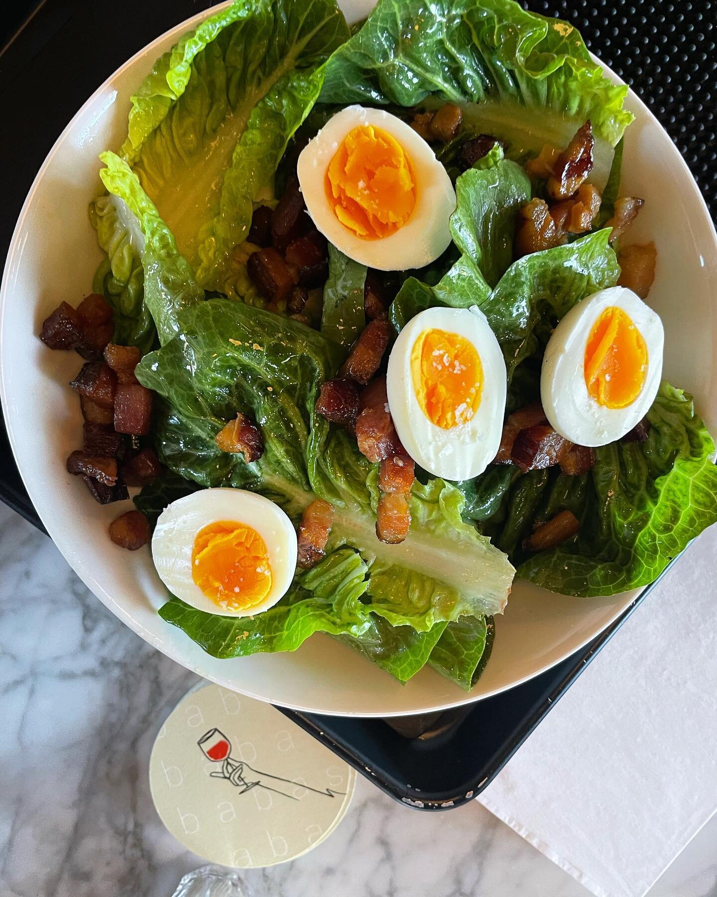 our take on a lyon salad at the meeting st location - sweet gem lettuce, bacon vinaigrette, @storey_farms eggs, and @nueskes bacon lardons