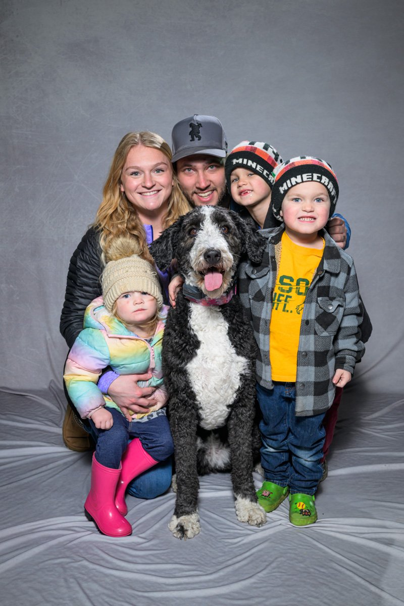 studio-vibe family with kids photo with black and white dog