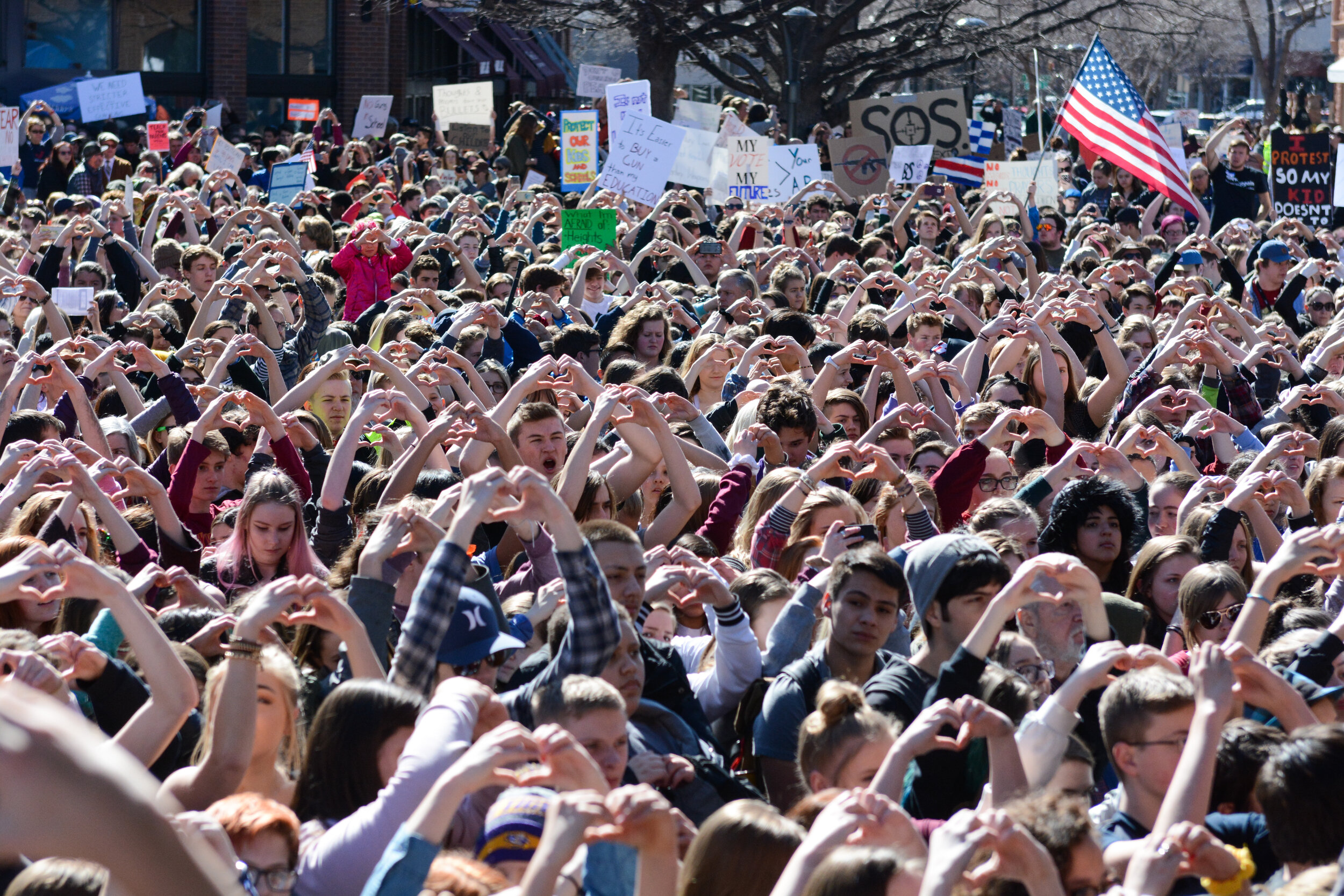 Protesters create hearts with their hands during the Walk Out protest on Feb. 27, 2018, in the Old Town Square in Fort Collins, Colorado. The protest was held by students, parents, and community members to pay respects to the children killed in the S