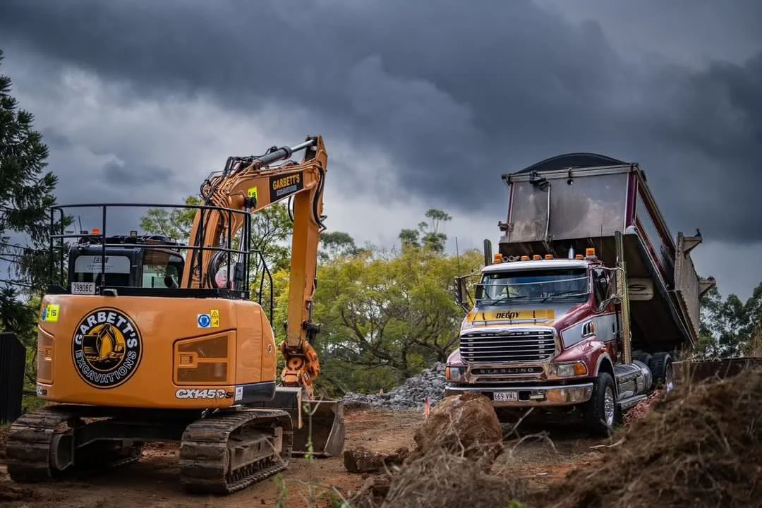 An excavator and tipper truck combination at work exemplifies efficient civil excavation practices for leading building contractors in the vibrant Northern Rivers NSW Region. Collaborating seamlessly, our team executes precision excavation and materi