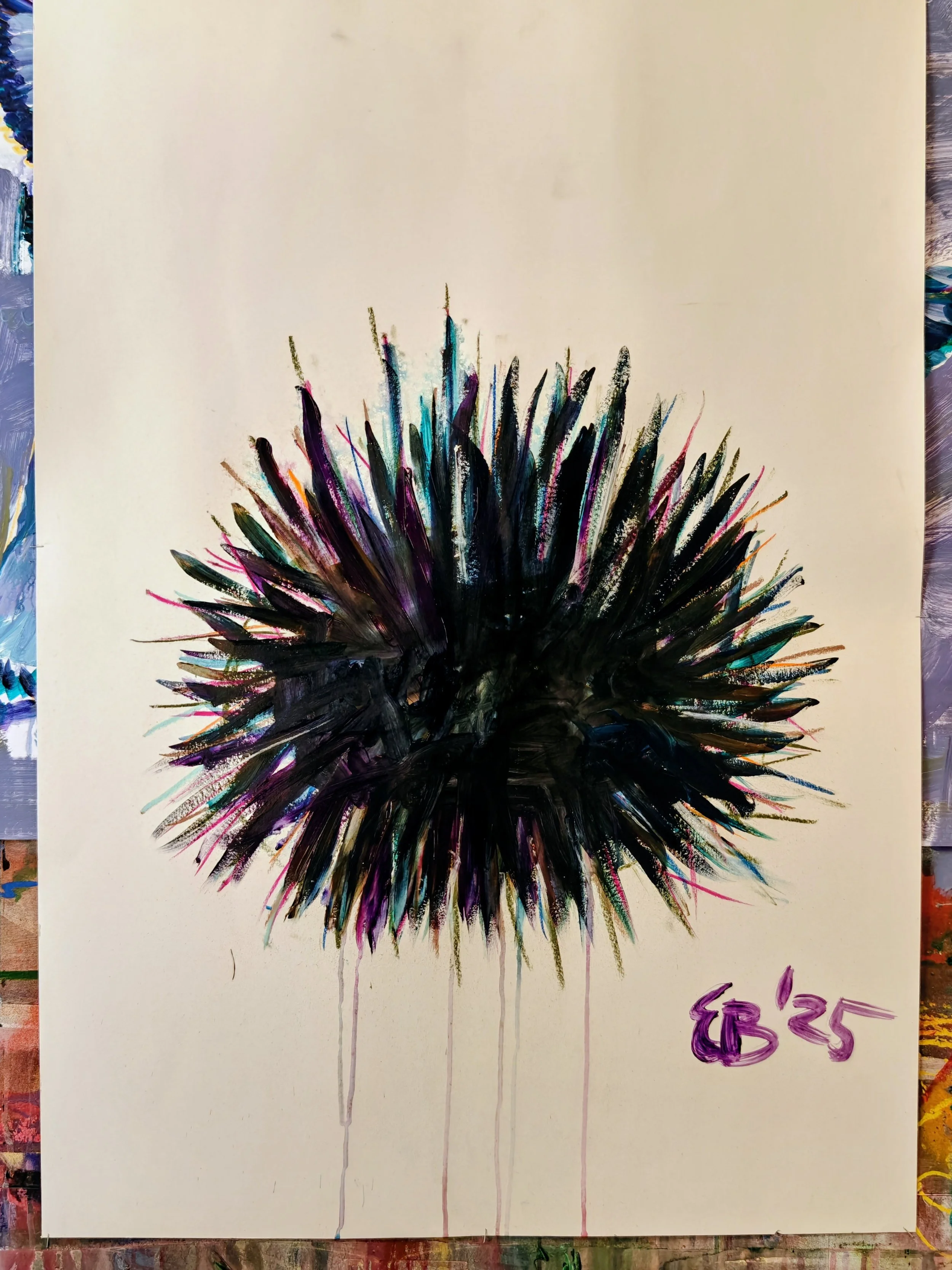 Abstract artwork of a spiky, rounded shape with streaks of black, purple, blue, and pink ink on a beige background. The artist's initials and the year 'G'85 are written in purple in the bottom right corner.