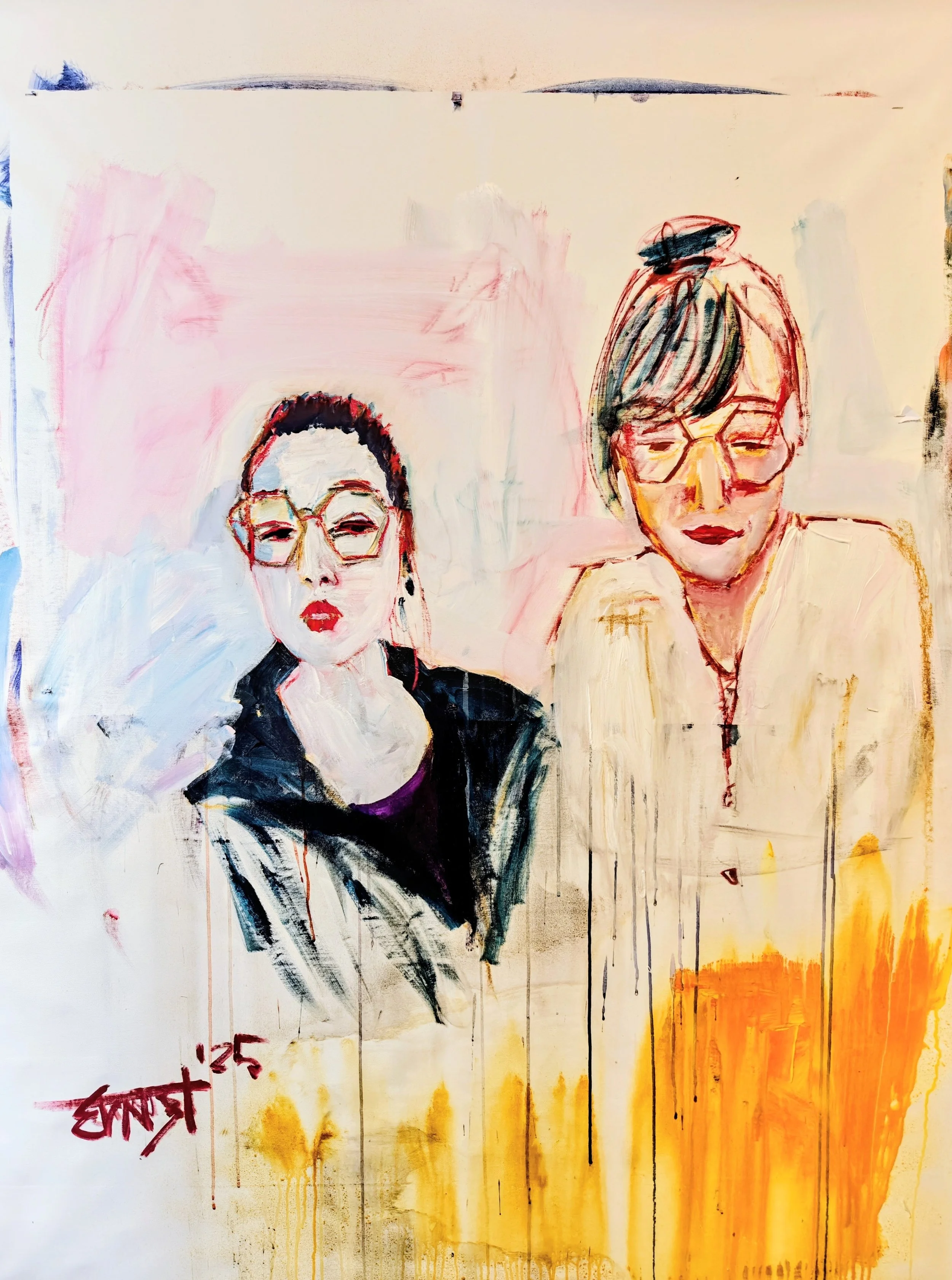 A colorful abstract painting of two women wearing glasses. The woman on the left has dark hair, red lipstick, and is wearing a black jacket. The woman on the right has light brown hair in a bun, wears glasses, and has a neutral expression. The backgr
