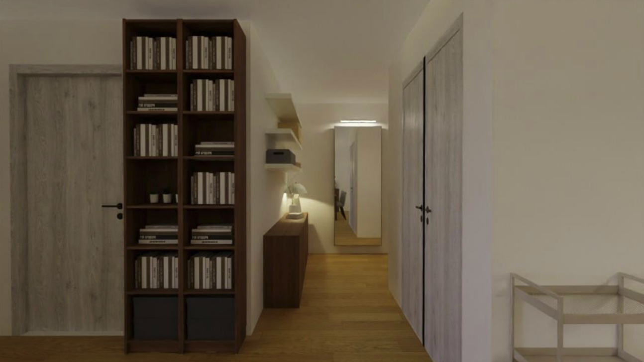 Hallway with wooden floors, white walls, a tall bookshelf with many books, a sideboard with a lamp, a large mirror, a closet with sliding doors, and a small wooden table with a mesh basket.