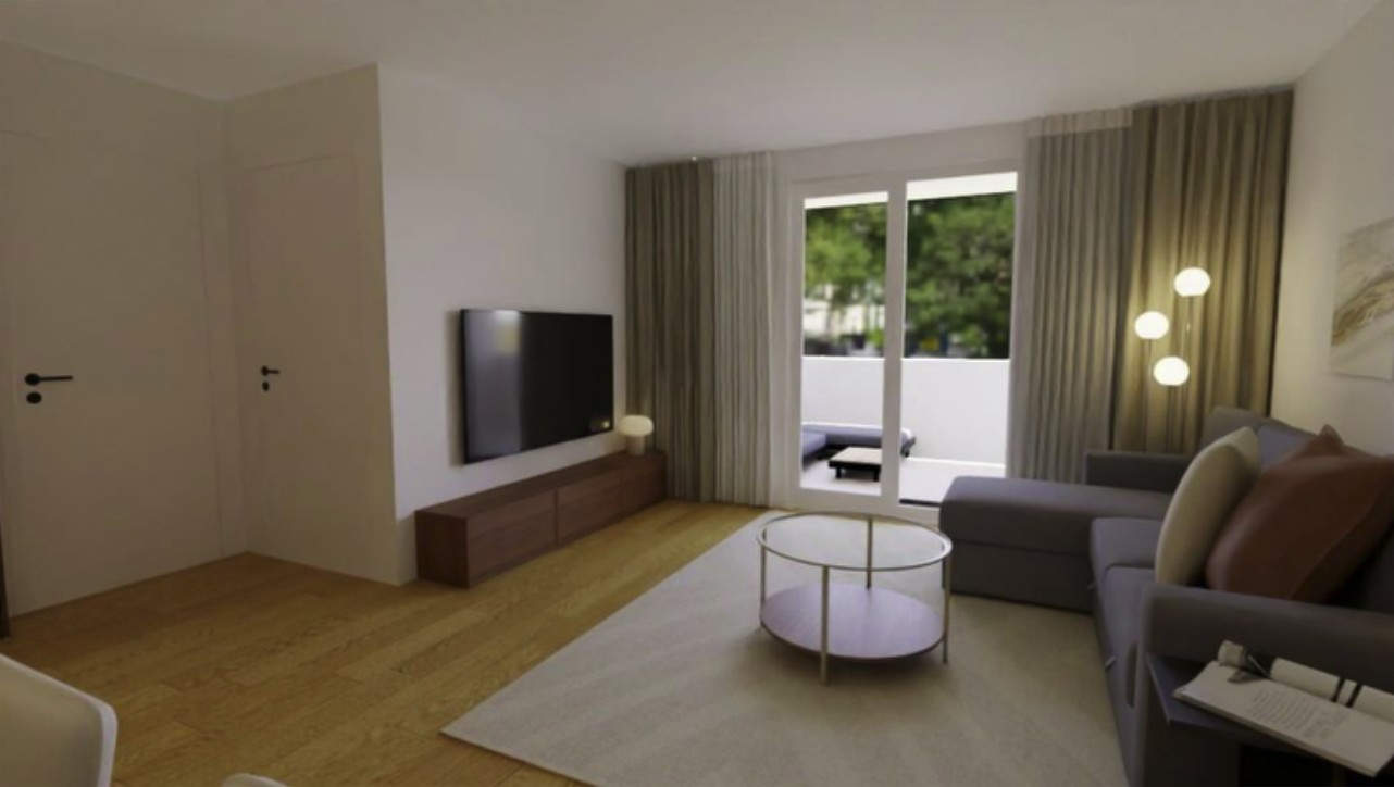 Living room with a gray sofa, glass-topped coffee table, wall-mounted TV, sliding glass door with beige curtains leading to a balcony, and floor lamp with globe-shaped lights.