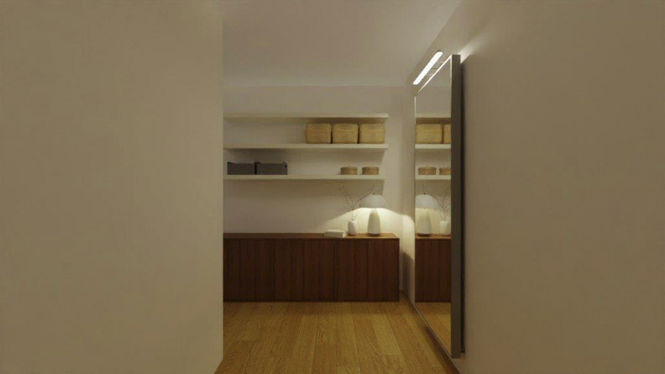 Minimalist hallway with a wooden floor, a large mirror on the right wall, and a built-in wooden cabinet with decorative lamps and shelves with beige storage boxes.