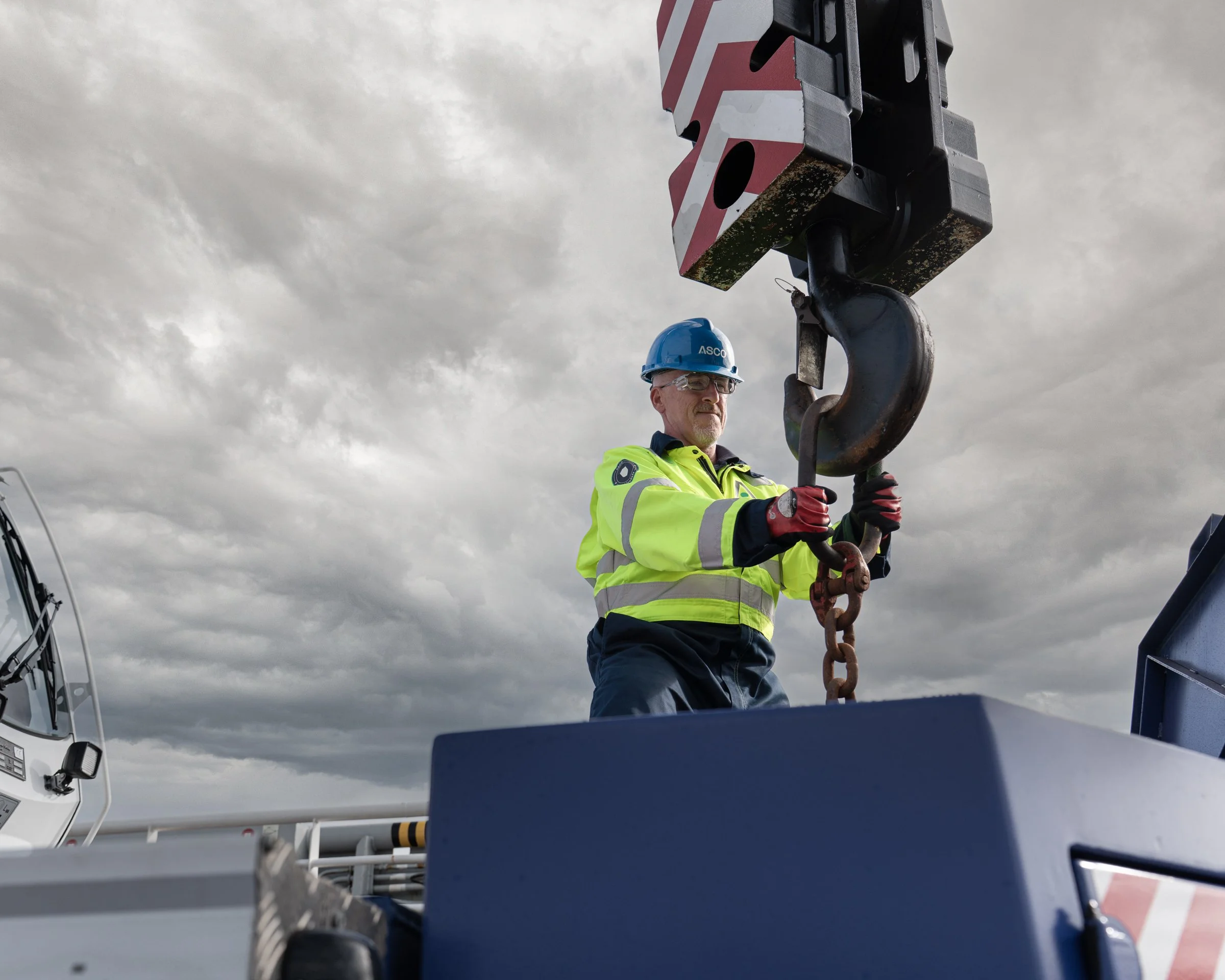 Person in a hard hat operating a crane