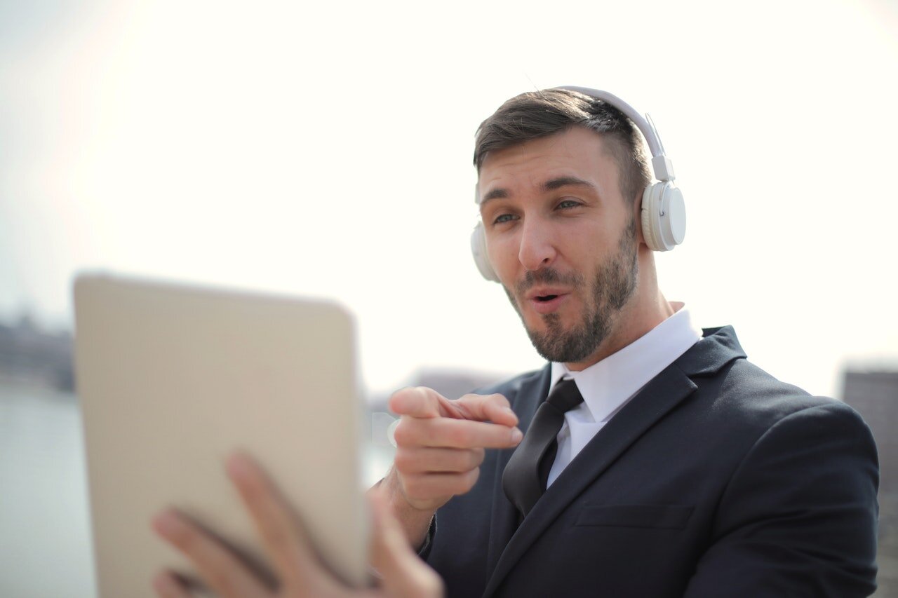 man-in-black-suit-jacket-while-wearing-white-headphones-3778844.jpeg