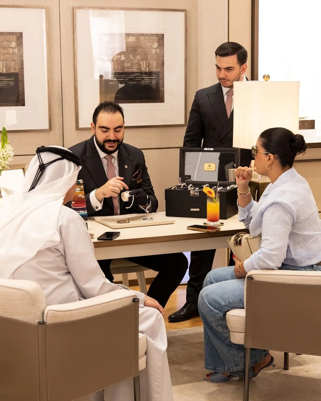 Luxury jewellery consultant assisting VIP clients during an exclusive Alaghband Jewellery event in Dubai.