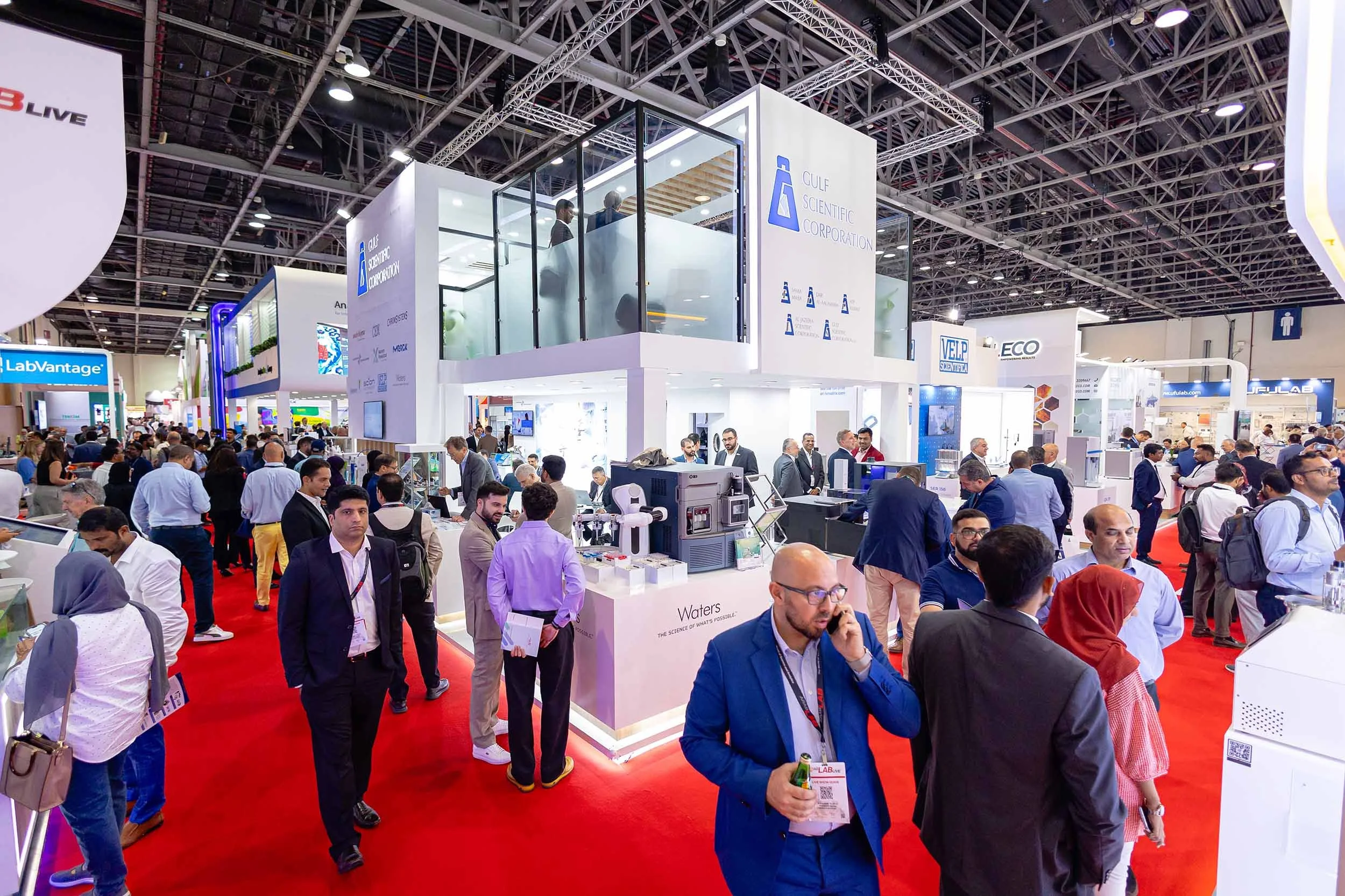 Exhibition visitors exploring booths during a large international trade show in Dubai with professional event photography coverage.