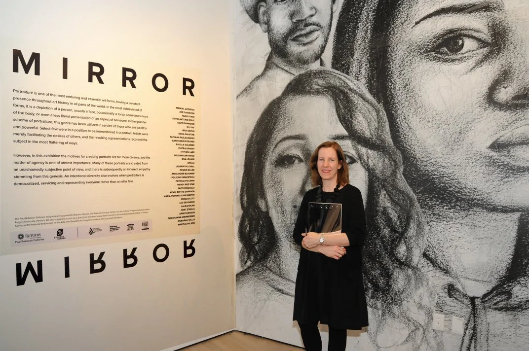 Paul Robeson Galleries Director & Chief Curator Anonda Bell at the Opening Reception for Mirror Mirror exhibition at Express Newark in 2018. Works, in a variety of media from thirty-two international emerging and established artists and one artist collective, plumb the relationship between identity, cultural norms, and representation. https://paulrobesongalleries.expressnewark.org/exhibition/mirror-mirror/
