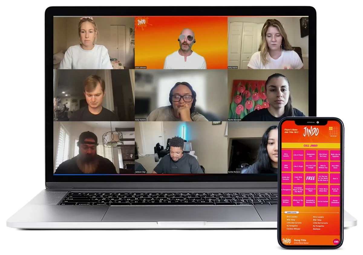 Laptop running Zoom virtual meeting alongside a mobile phone showing a Jindo game card.