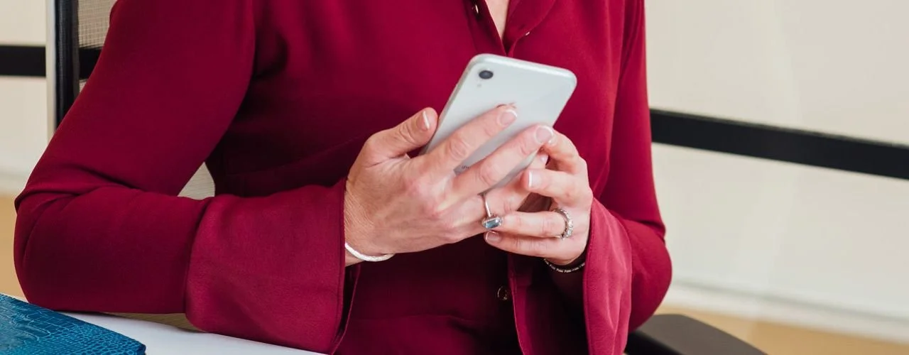 Pictured: Suzie Walker and smart phone | Leadership Hiring Trends for 2026 | Suzie Walker Executive Search