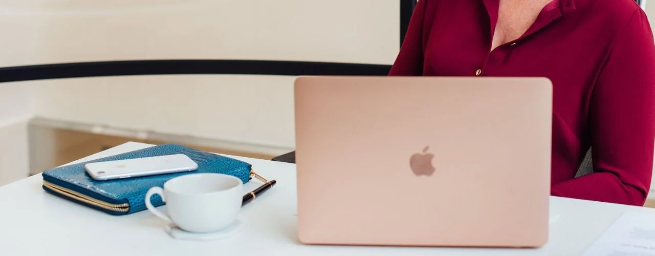 Pictured: headhunter's desk with laptop and mobile phone | How Headhunters Identify High-Impact Marketing and Digital Leaders | Suzie Walker Executive Search