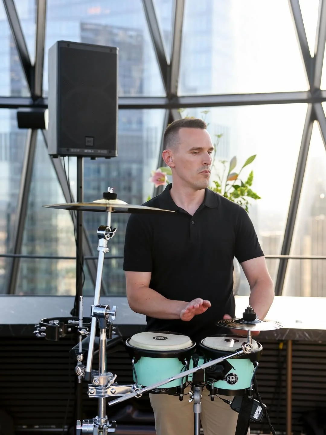 Professional wedding bongo player performing with a DJ at a modern rooftop wedding venue