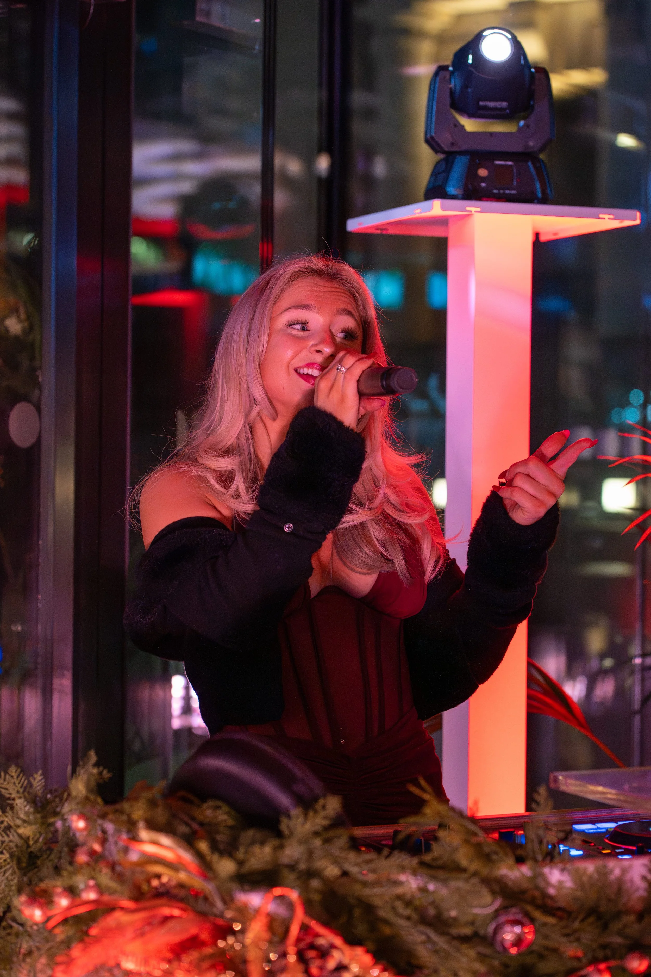 Resident DJ and live vocalist performing at a bar event, delivering a polished live music experience for hospitality guests