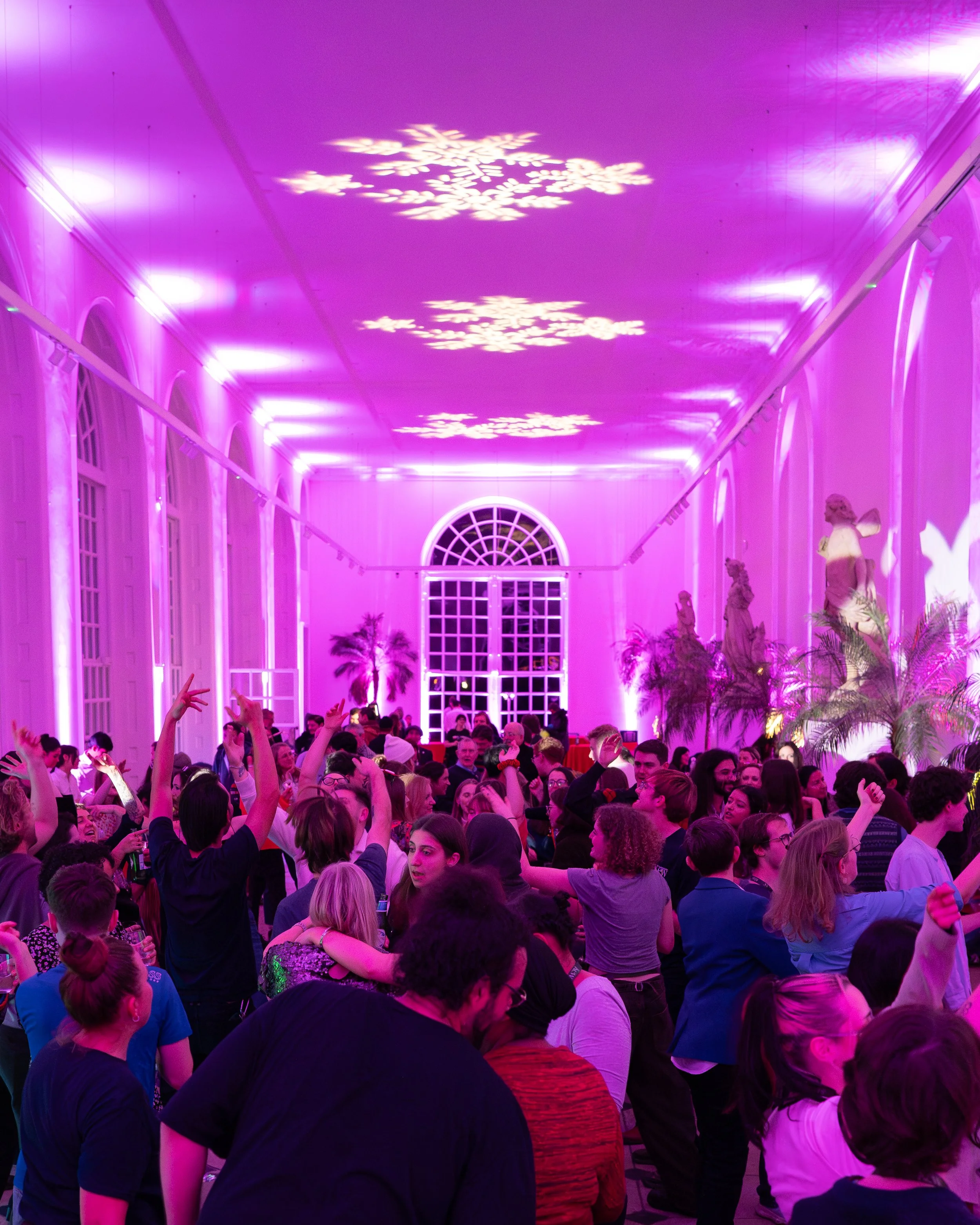 Corporate Christmas party dancefloor with festive lighting and DJ entertainment