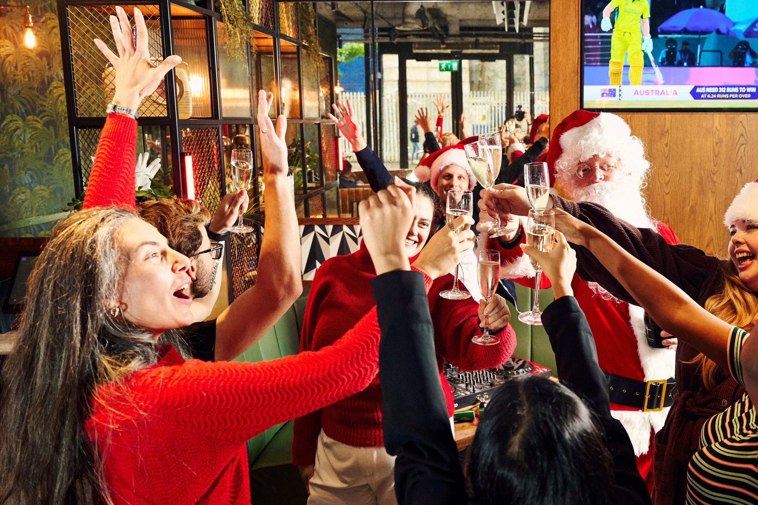 Guests celebrating at a corporate Christmas party with DJ and festive atmosphere