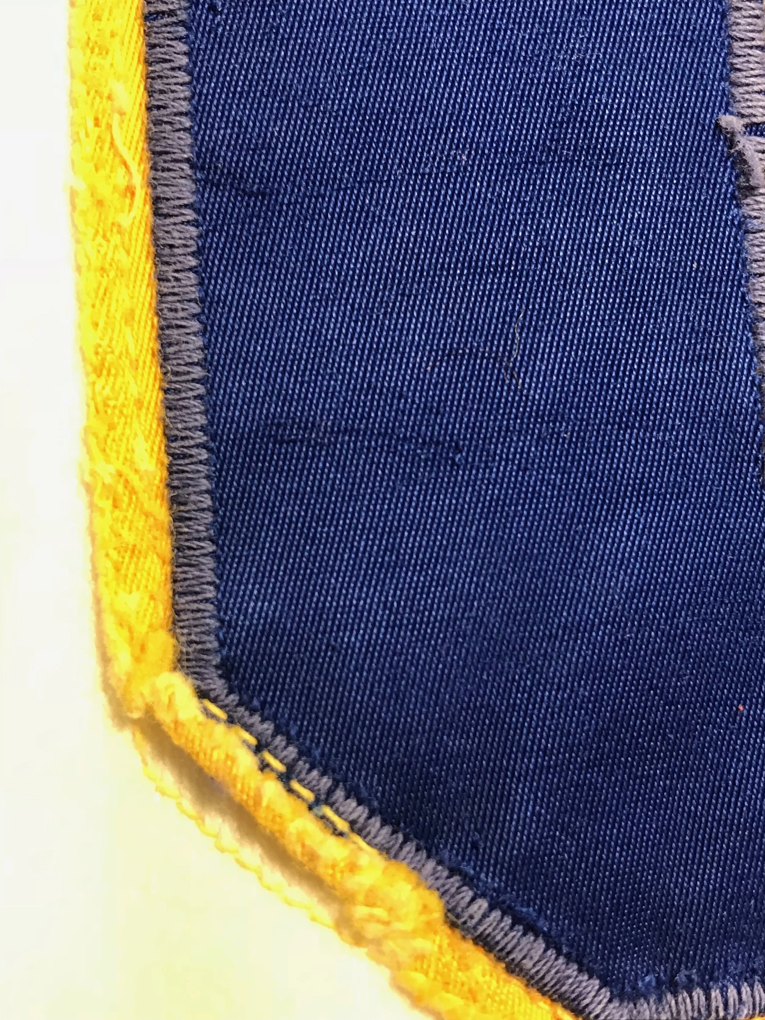A look at how the replacement back number was sewn on -- with a straight stitch instead of a zig zag -- allowing all the edges to fray.