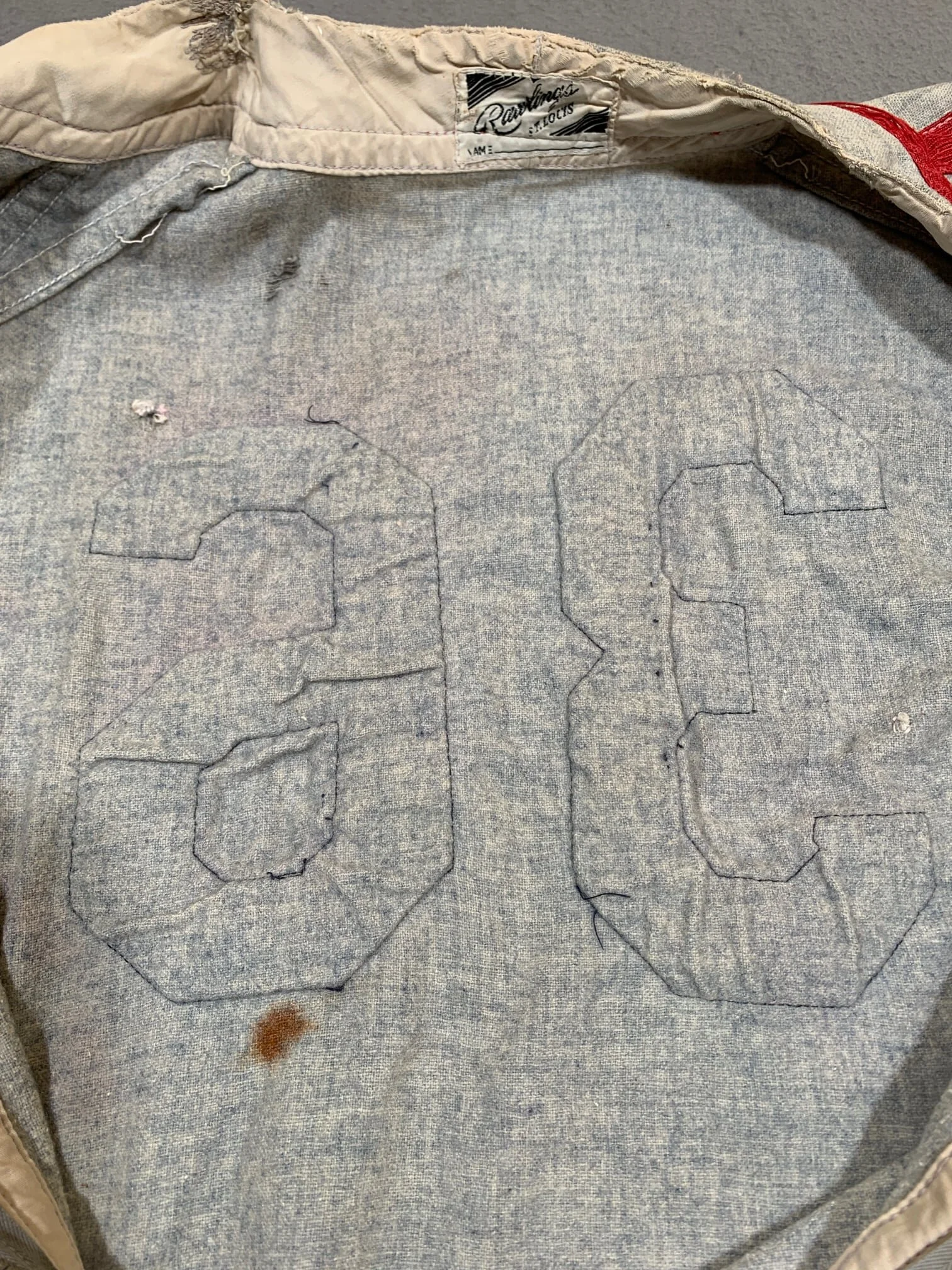 From the back side, notice the puckering of the flannel fabric under the felt numbers. This shows that the numbers and the jersey fabric had shrunk at different rates after many hot water washings.