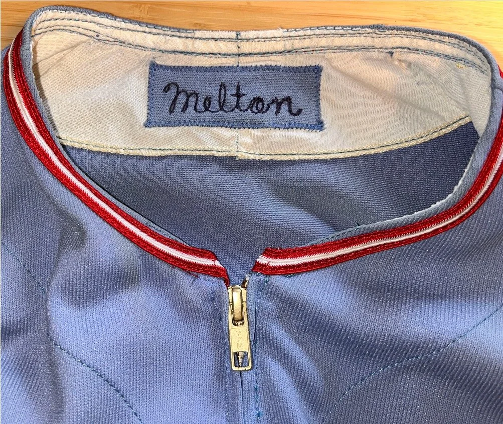 Emily stitches the trim in place, and you can see how bright and clean the formerly yellowed linen lining inside the collar is after all our work. 