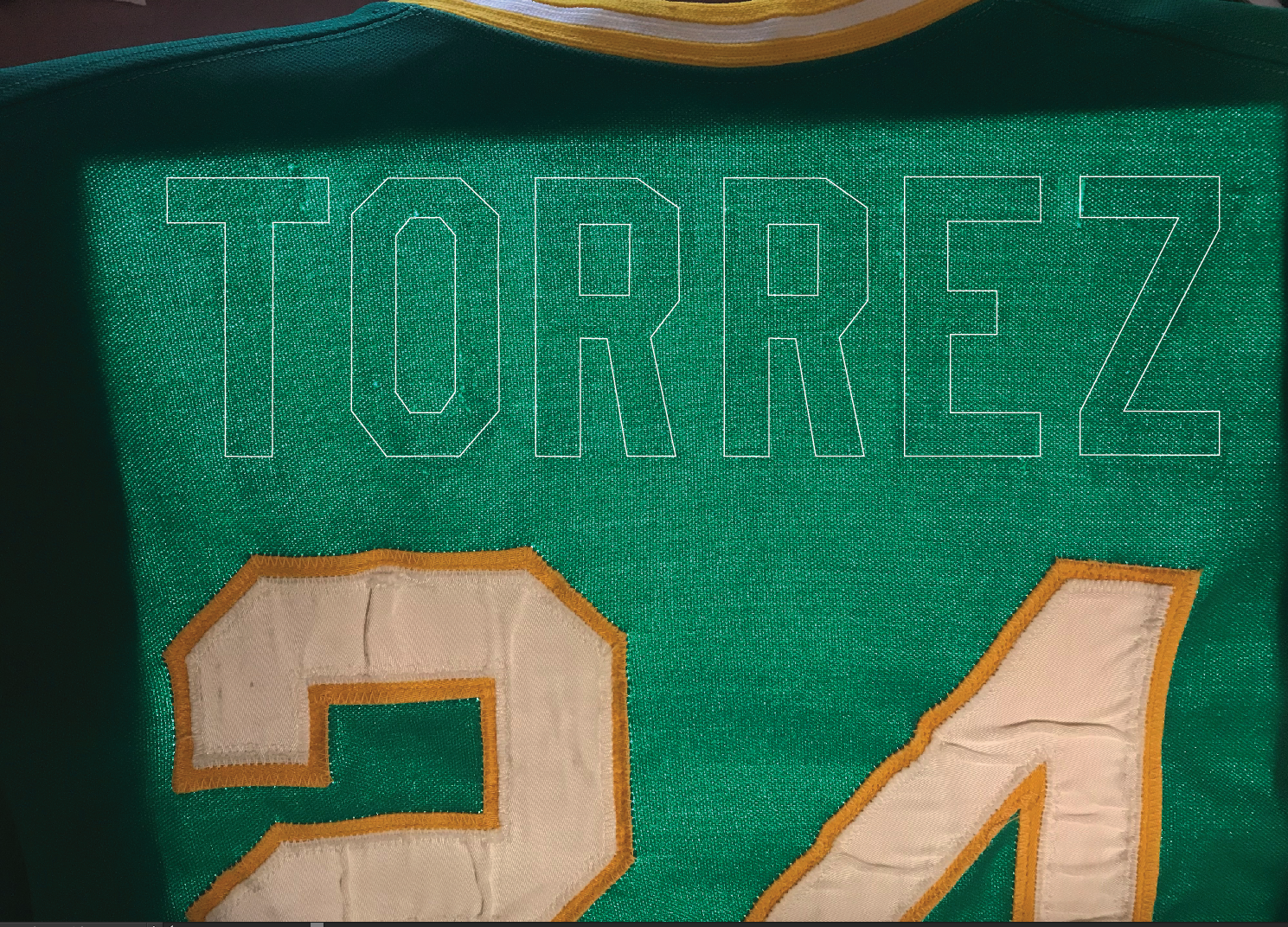 The ghosts are visible on the light table. Note the distortion on the ends -- I avoid sewing new lettering on crooked like this... it just looks wrong. 