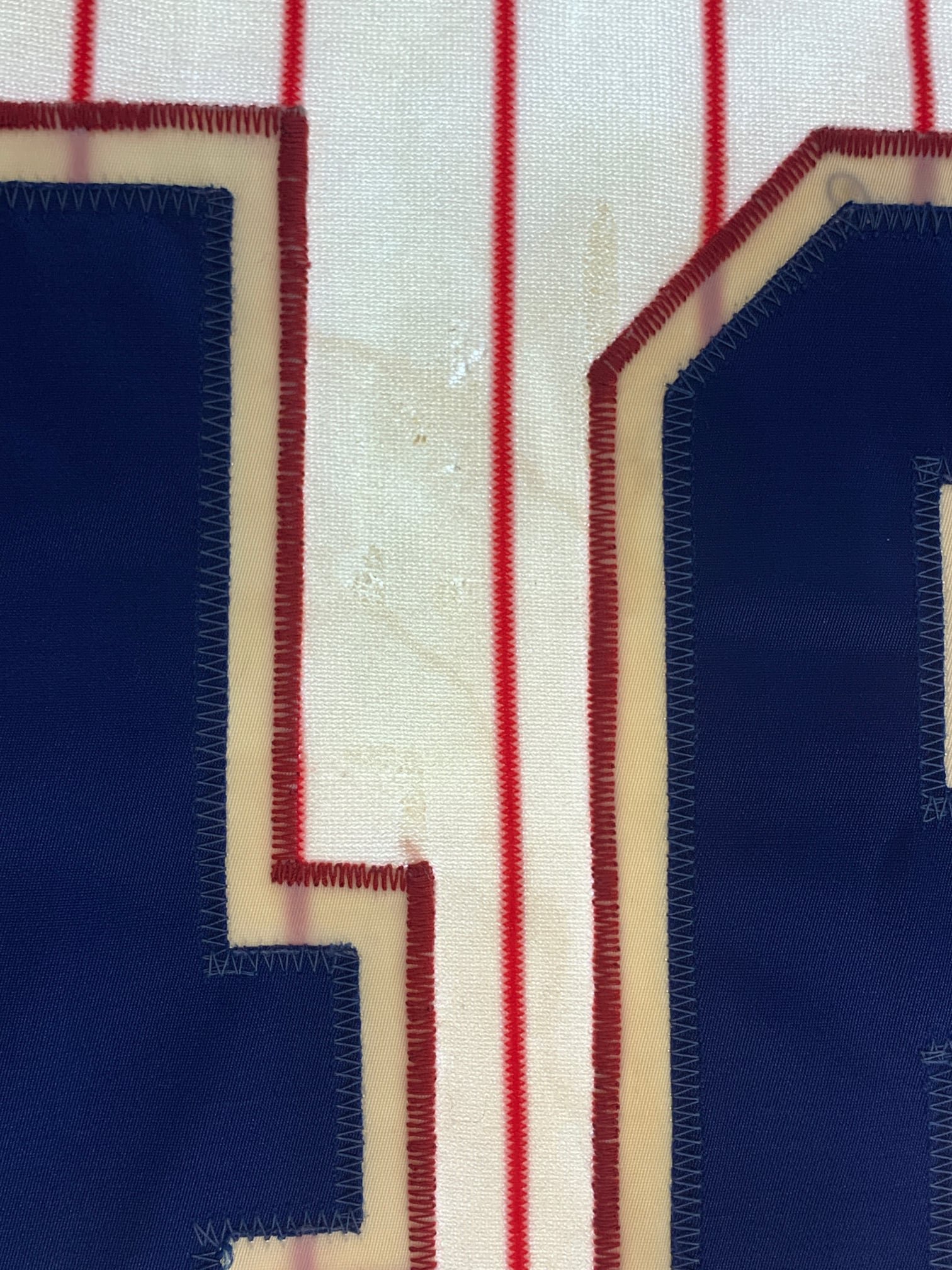When it arrived, it was clear that the jersey had done several tours of duty. While the front numbers could have been original, The back numbers were not, and on the light table it was clear that another set of two numbers had been on the back before