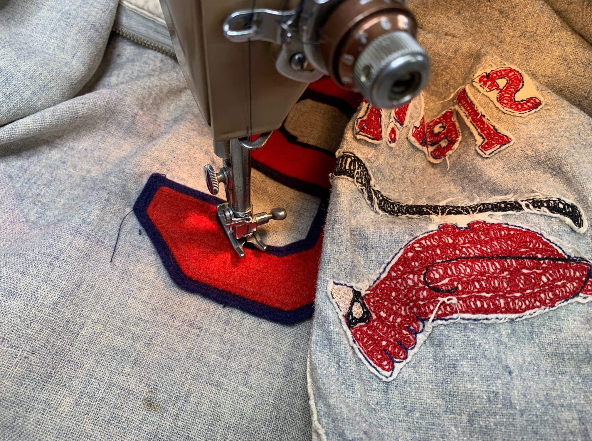 All that remained was to stitch the number in its proper place. We employed a straight stitch, as that was how felt numbers were once sewn. The zig-zag sewing machine wasn’t even invented at the time that this garment was made!