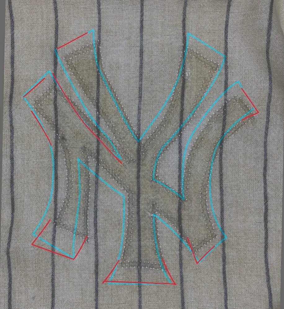 A light table examination of the front shows that the NY logo is not the original one. Slight shadows exist of the original crest, but notably the entire left side of the chest was darker as if something else might have been glued there. I wondered, 