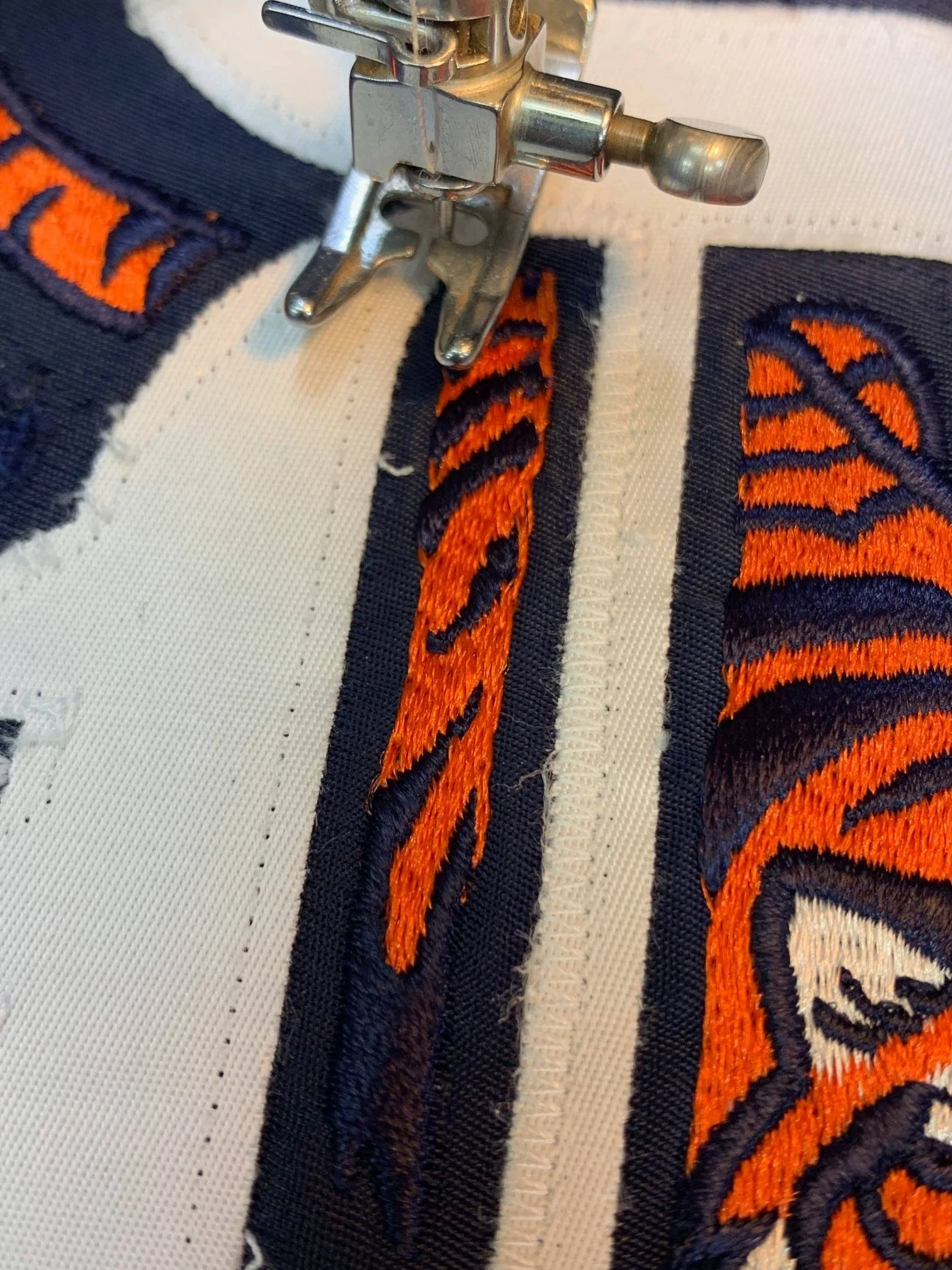 Using my own game jersey as a positive match for the sizes of the numbers back and front, I cut new ones. I stitched everything onto the historic jersey using the light table for placement. 