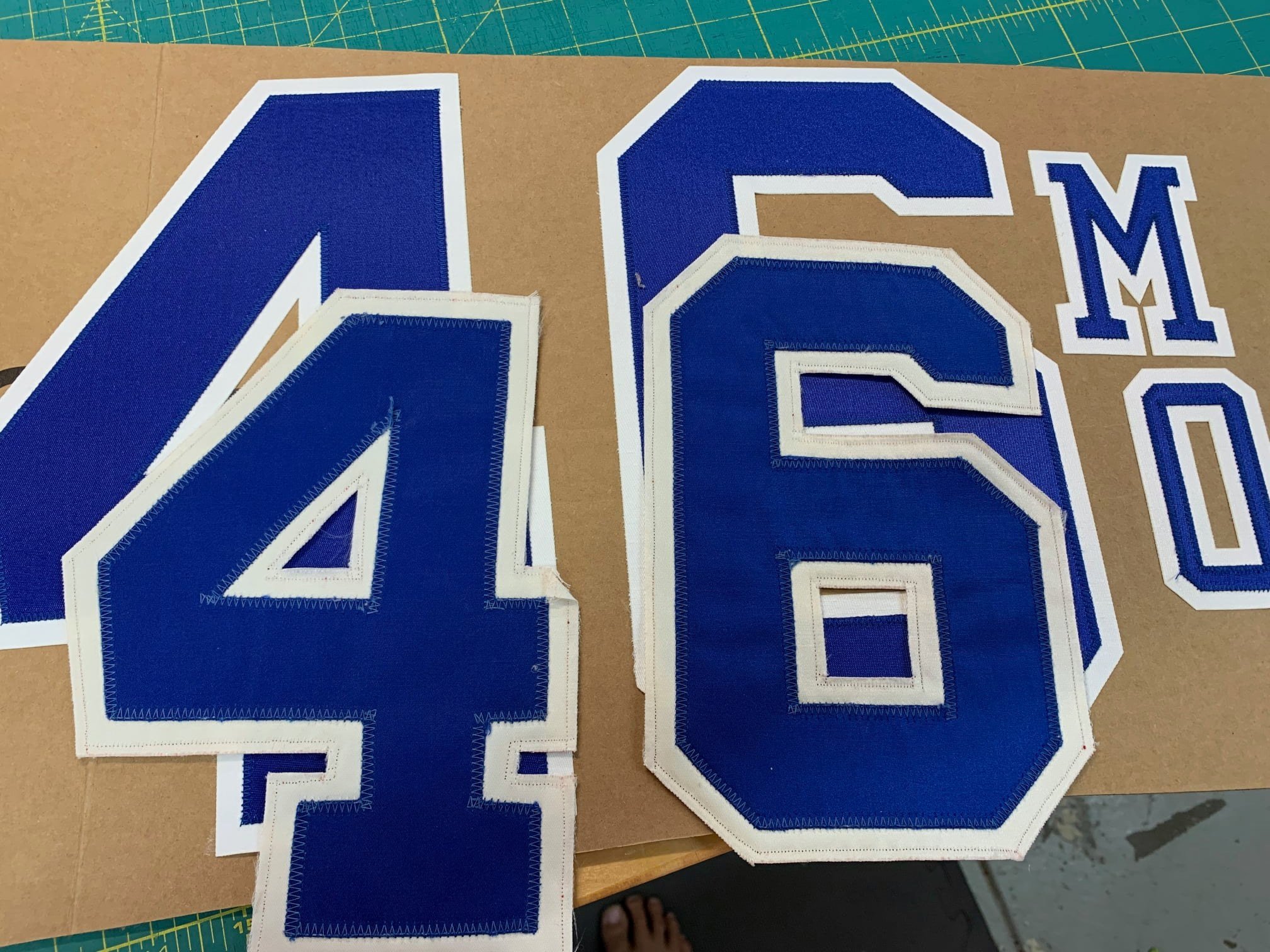 The next step is to make the new lettering match the old in terms of color and patina. After being washed dozens of times and worn on the field in dozens of games, the twill lettering doesn't look very much like it did when it was new. The shine is g