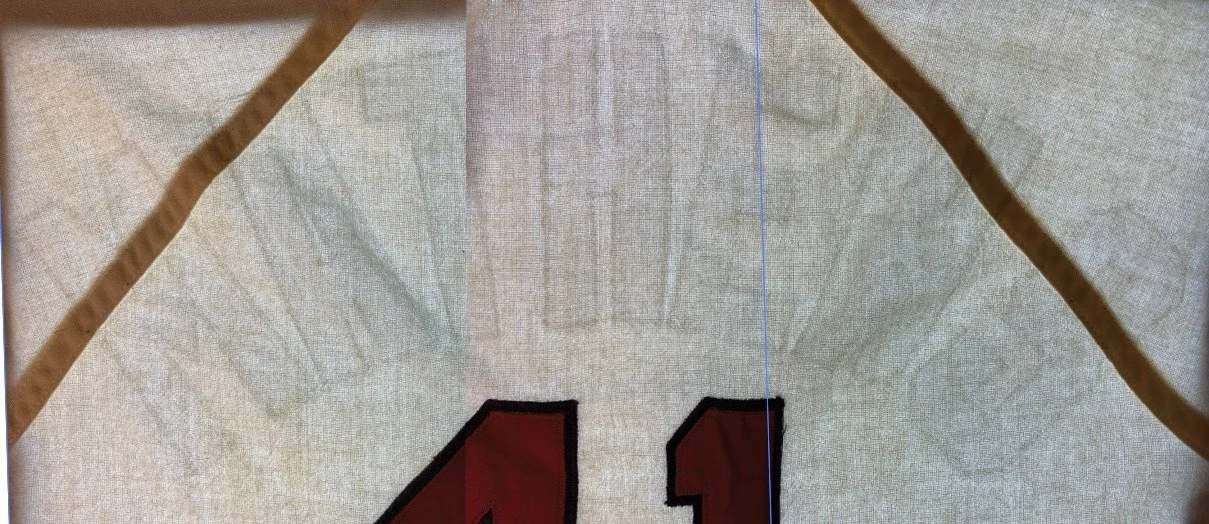 Next, I take high resolution photos of the jersey placed on the light table, and overlay the scanner’s images to match its 100% size. The shadows we can see are from the microscopic weave compression that remains from that stitching done 55 years ago