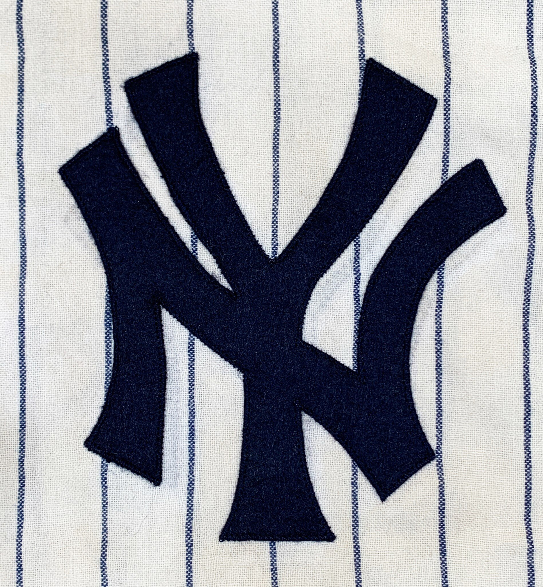 I re-created the original 1964 team pattern “NY” on front and #7 on back, in heirloom Merino wool felt. The original pattern matched the tell-tale ghosts perfectly! In the placement, I ensured that the new lettering covered the ghosts exactly before 