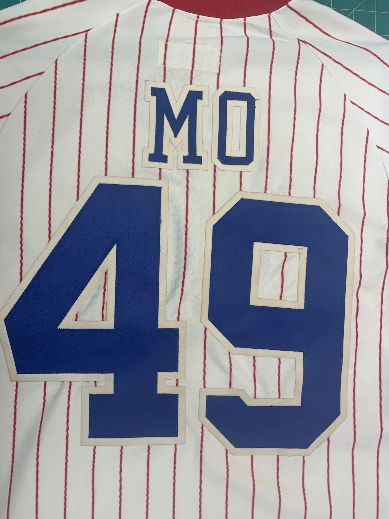 Finally, tacking the now-aged lettering in place over the old outlines required me to actually slightly pucker the fabric of the shirt beneath the new numbers. In its decades of use the Jersey had become misshapen, and to make all of the lines of the