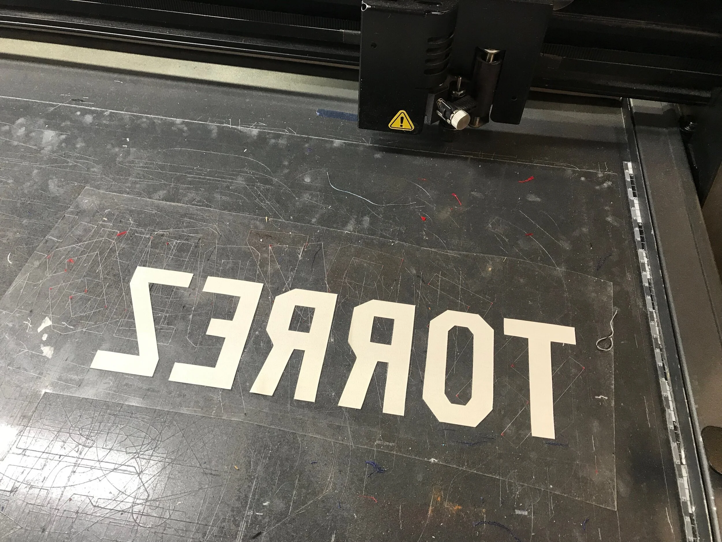 Laid out "pre-spaced" to perfectly match the ghost, we cut the NOB on the machine in mirror image so it can be exactly applied.