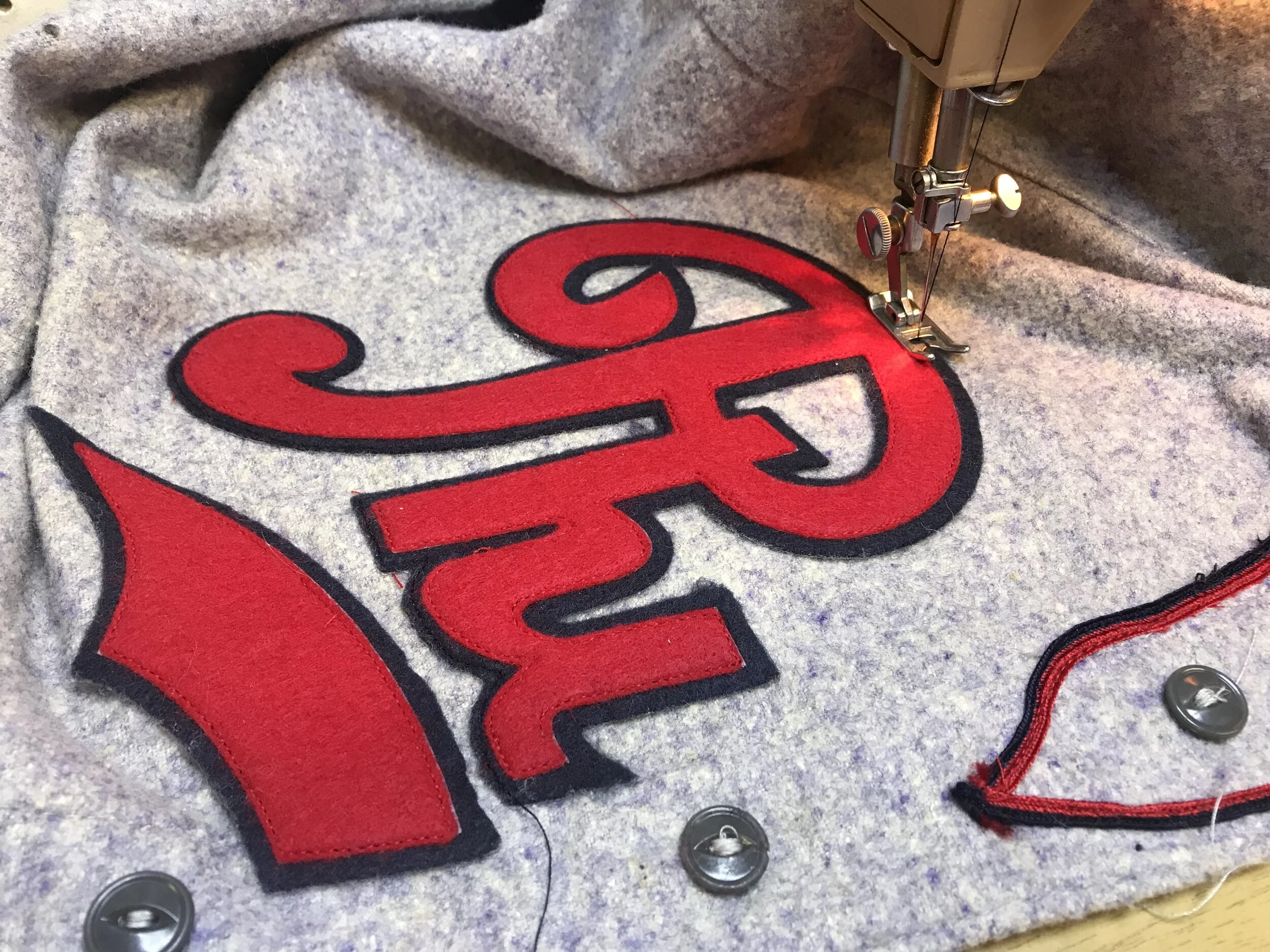 Properly placed and tacked with adhesive, the team logo is edge-sewn to the jersey with a straight stitch.