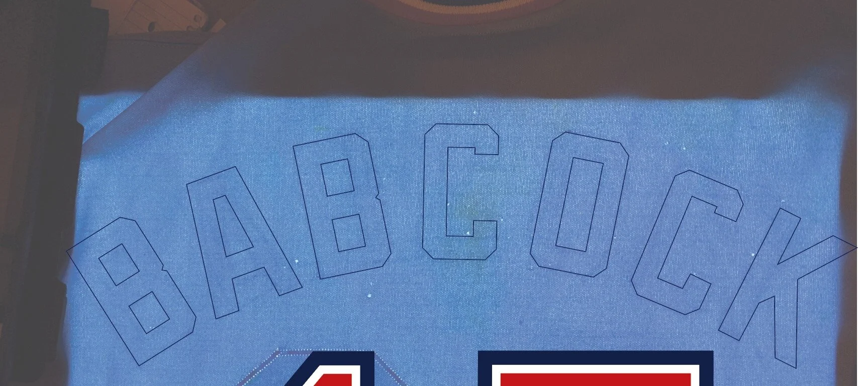 When put on the light table, I could clearly see the outlines of Babcock’s name there. But evidence of either the #17 or Ellis’ name were not readily apparent. This photo highlights Babcock’s name on back.