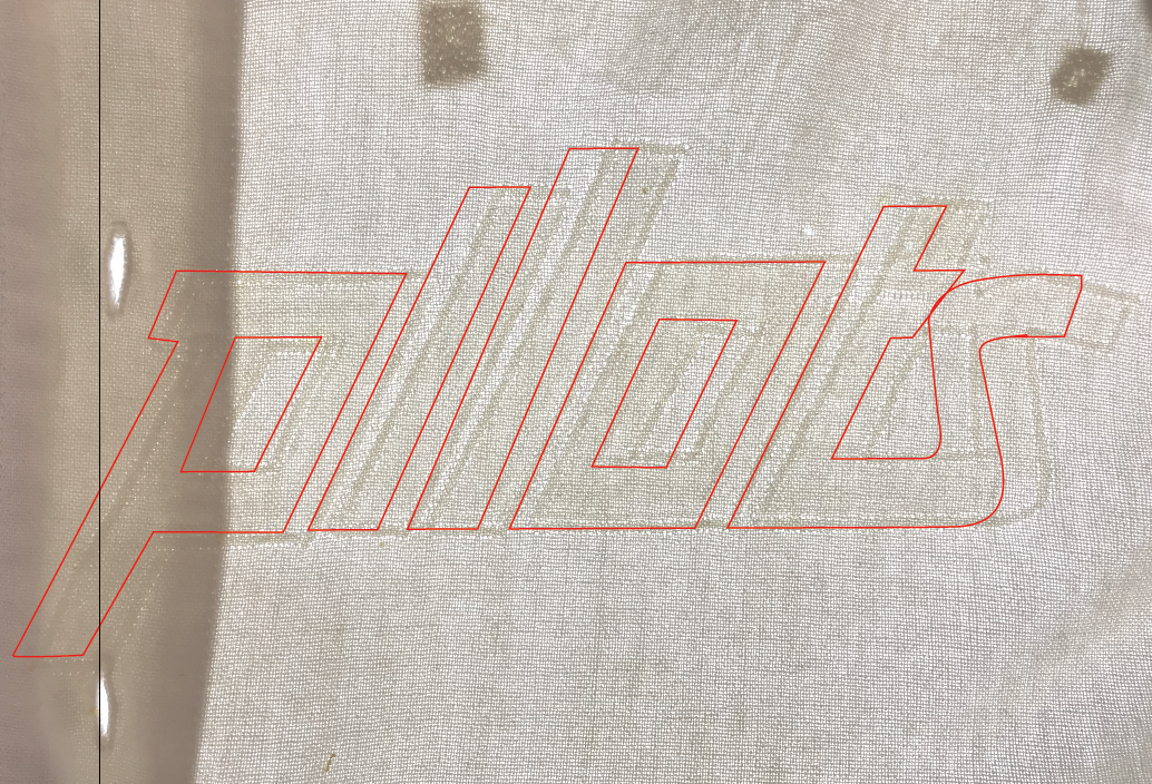 This tracing roughly shows us where the original lettering was sewn.