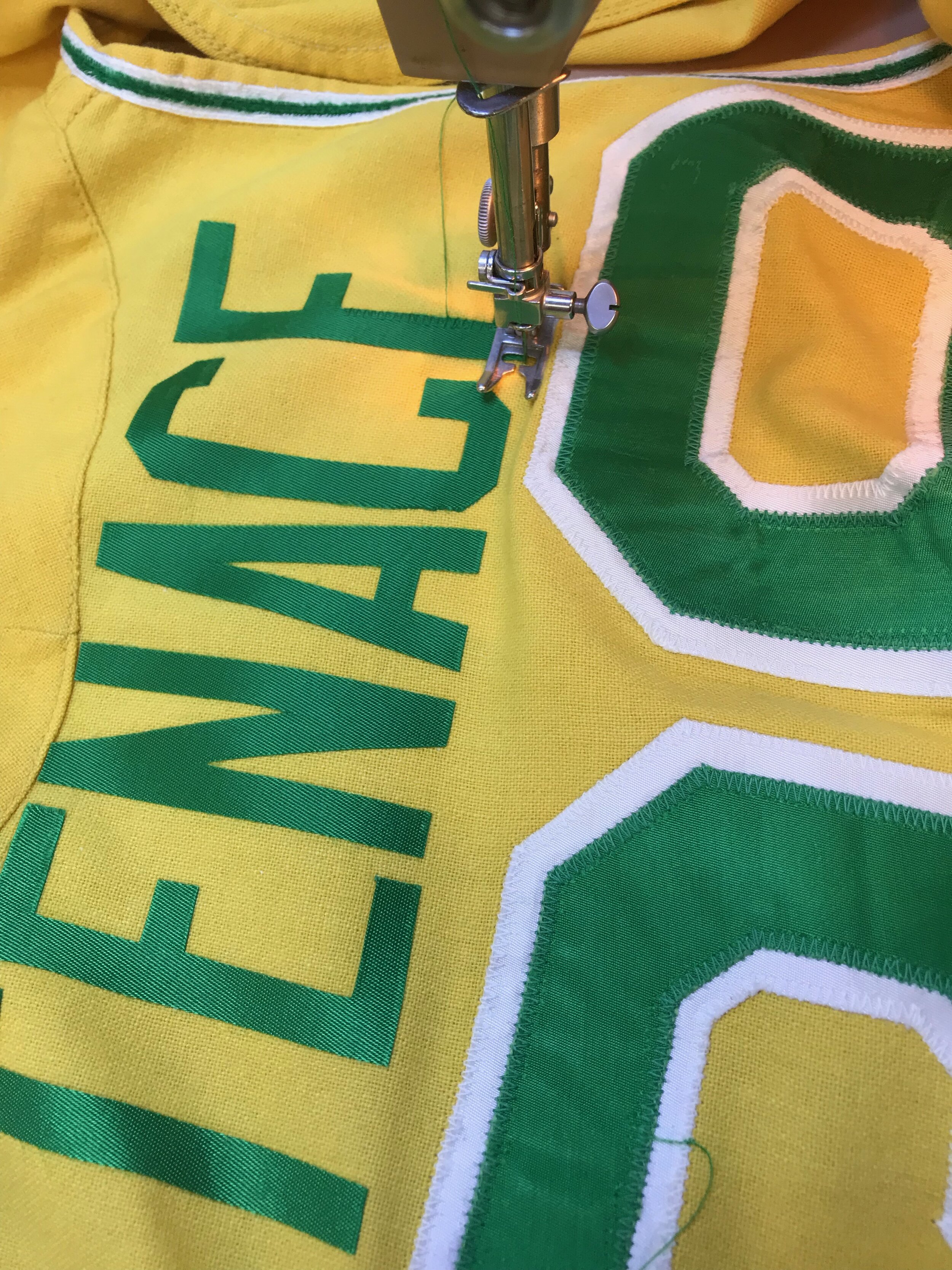 We stitch the jersey after the heat press "locks in" the correct placement. 