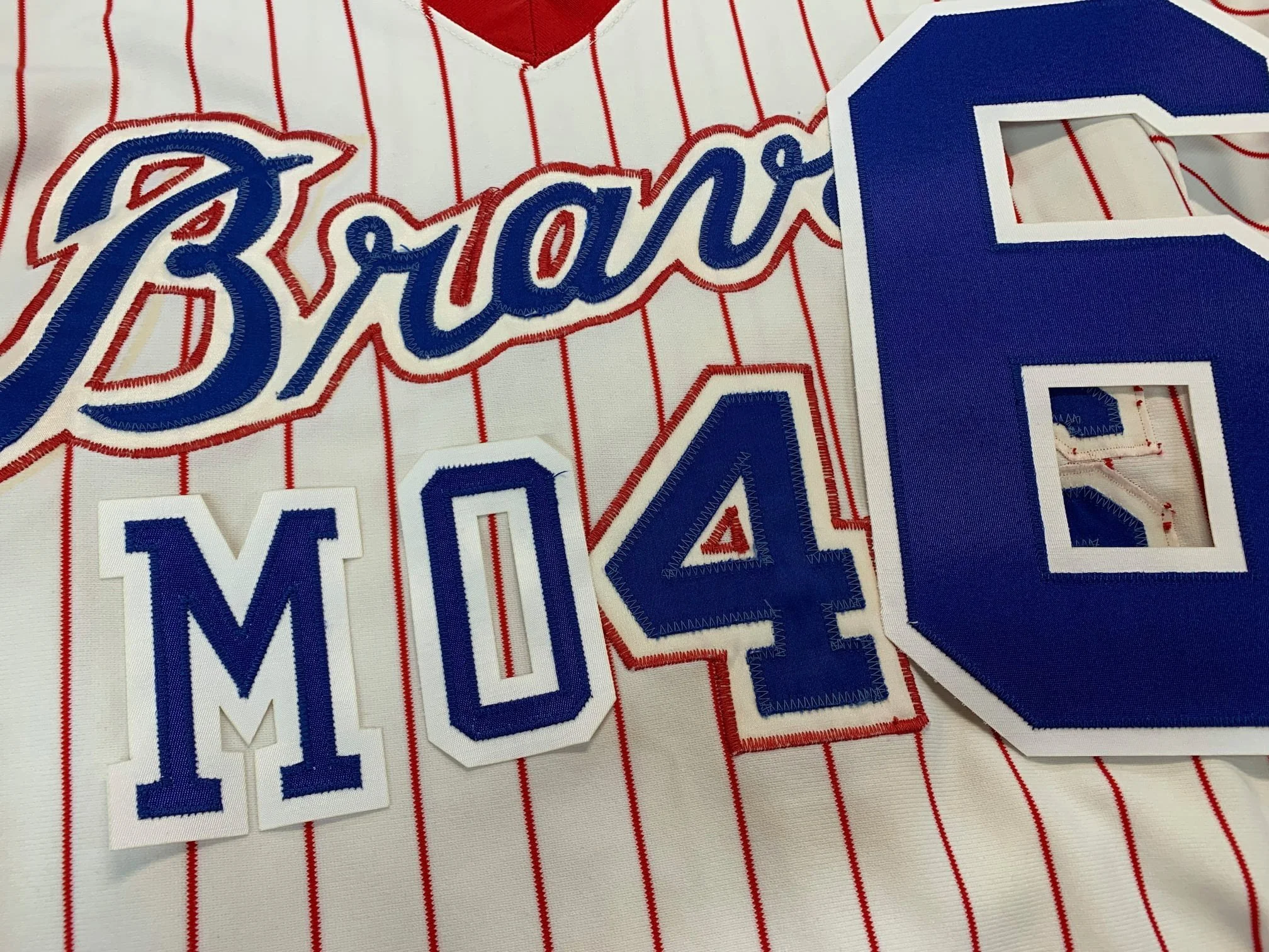 Using the ghost outlines of the numbers and name letters from the back, I re-created these in the appropriate colors of two layer tackle twill. The back numbers are a huge 9 1/2 inches tall. I don't think there's ever been taller back numbers on a je