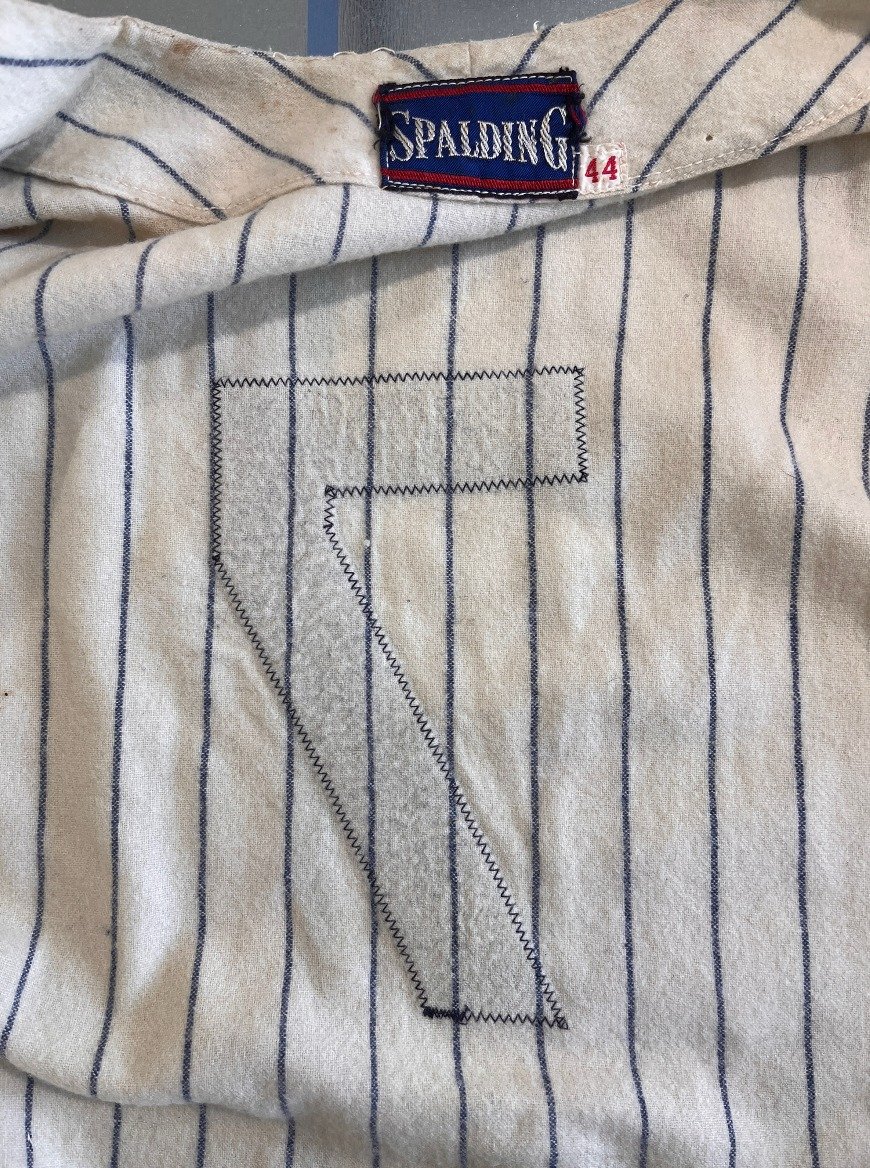 The light table shows that nothing has been changed on the back of this jersey, and the very fine and even puckering pattern of the flannel fabric beneath the felt number is impossible to reproduce. My conclusion is that the seven on the back is the 