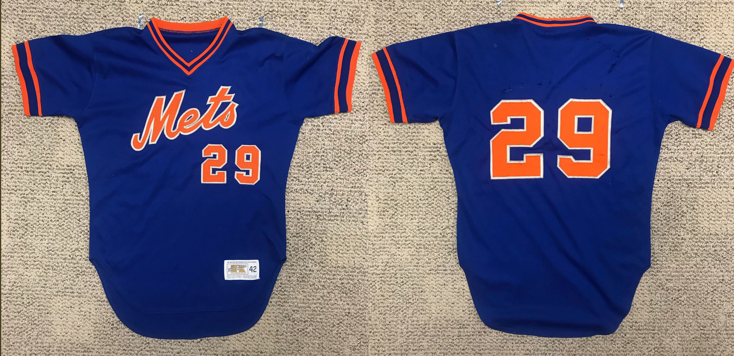 As it arrived at my shop. There were non-standard, Varsity-style variant numbers adorn both the back and front, and there was evidence of a nameplate having been rudely removed from the back. All lettering is dark orange outlined with gray, not white