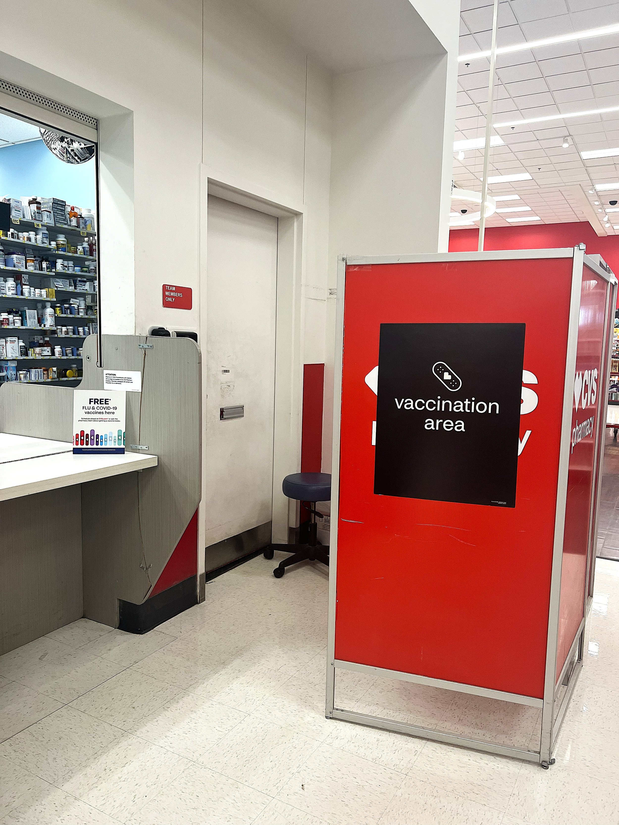 "Free* Flu & COVID-19 vaccines here" Printed Flyer in Acrylic Sign Holder, Vaccination Area at CVS Pharmacy in Target, Shoreview, MN - September 27th