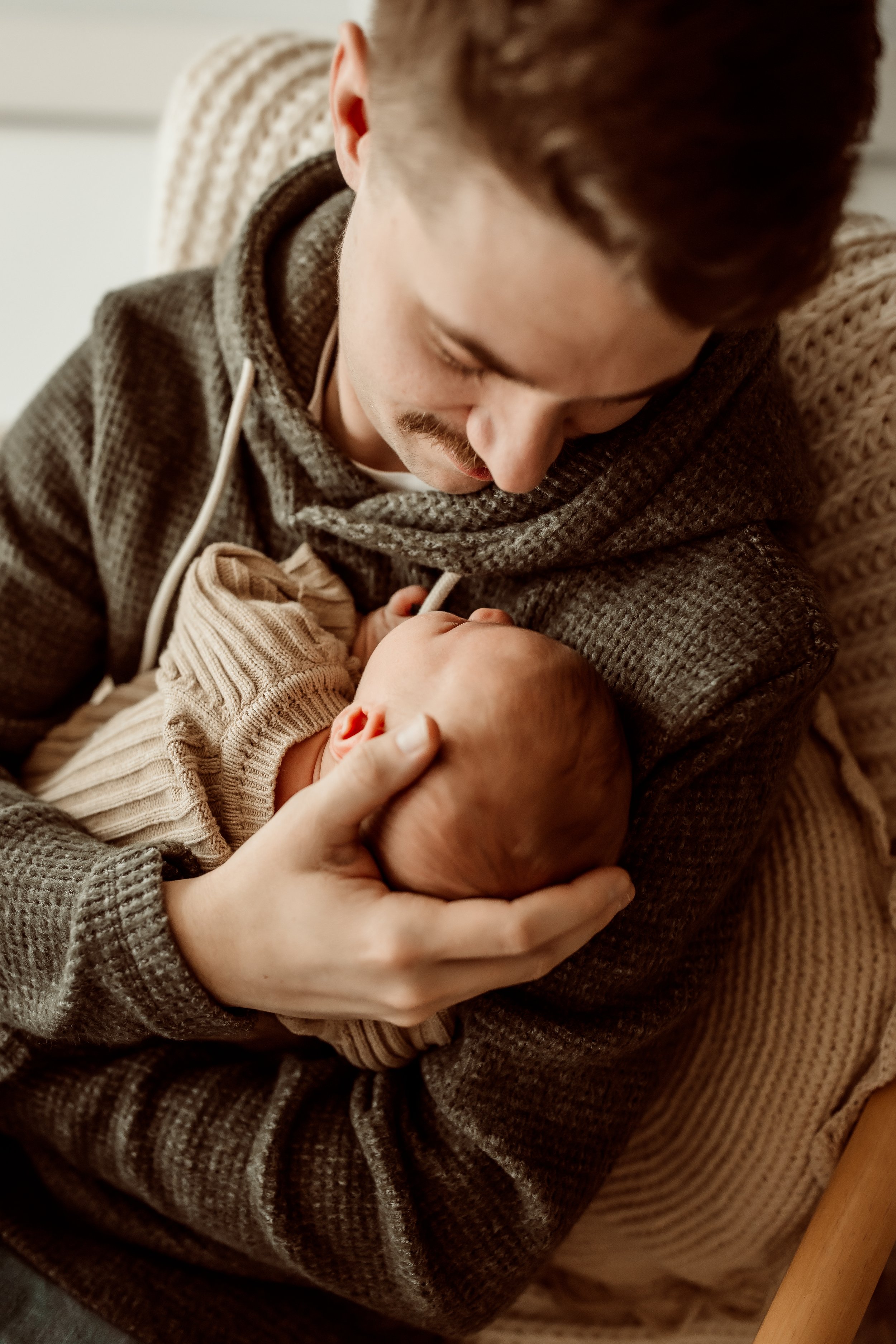 Beautiful newborn baby wrapped in a neutral cream swaddle