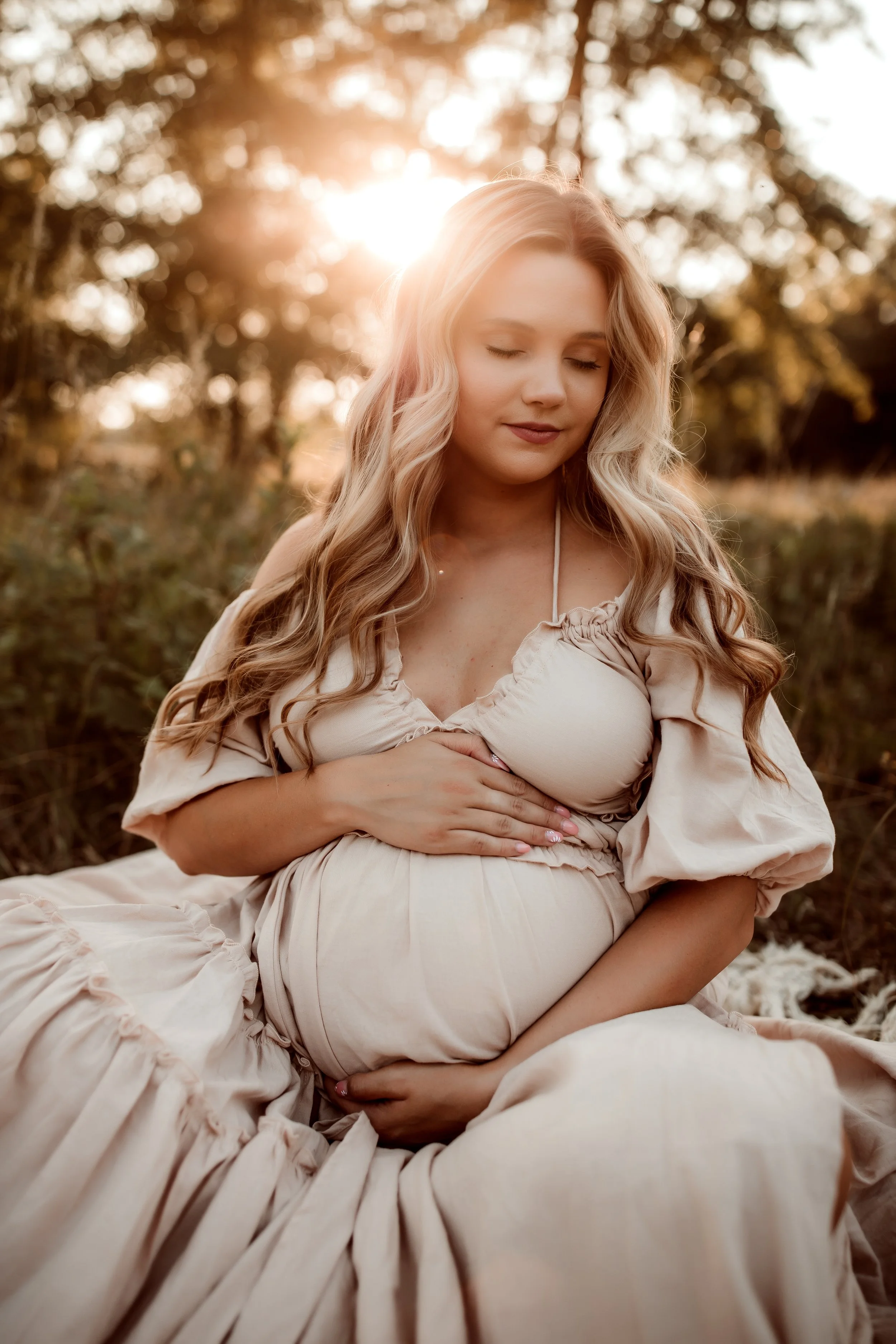 Beautiful pregnant belly in a maternity gown